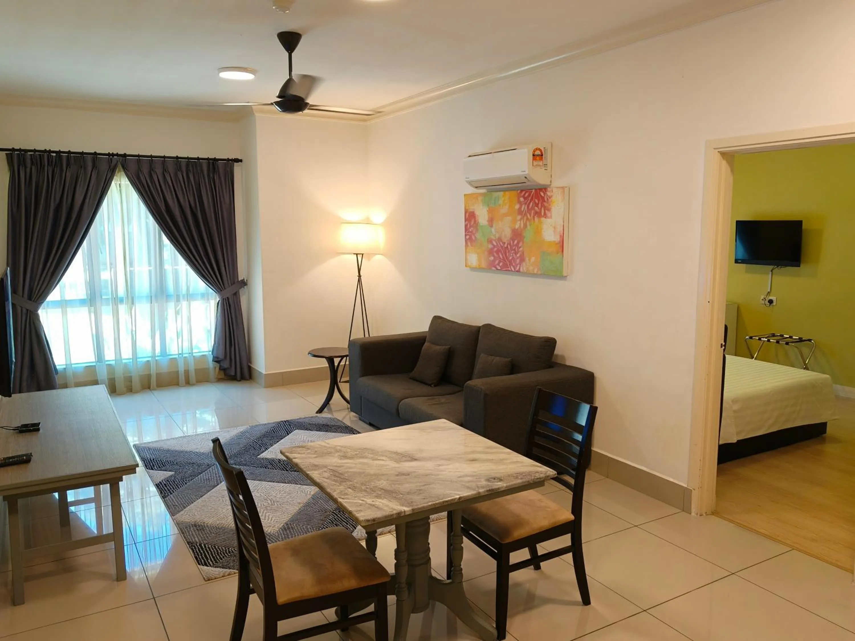 Living room, Bed in RPGC Garden Hotel