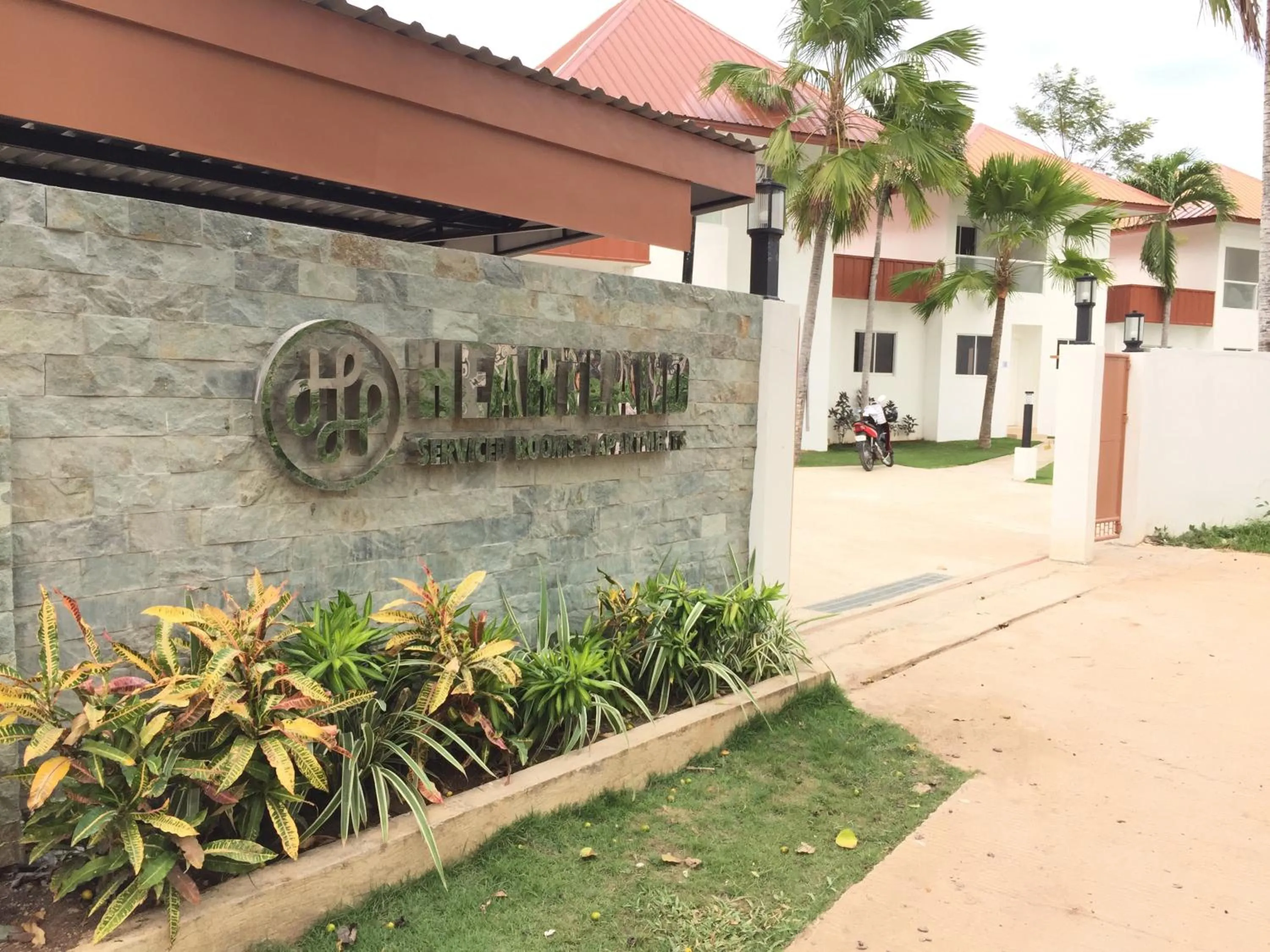 Property logo or sign in Heartland Hotel Serviced Rooms & Apartments.