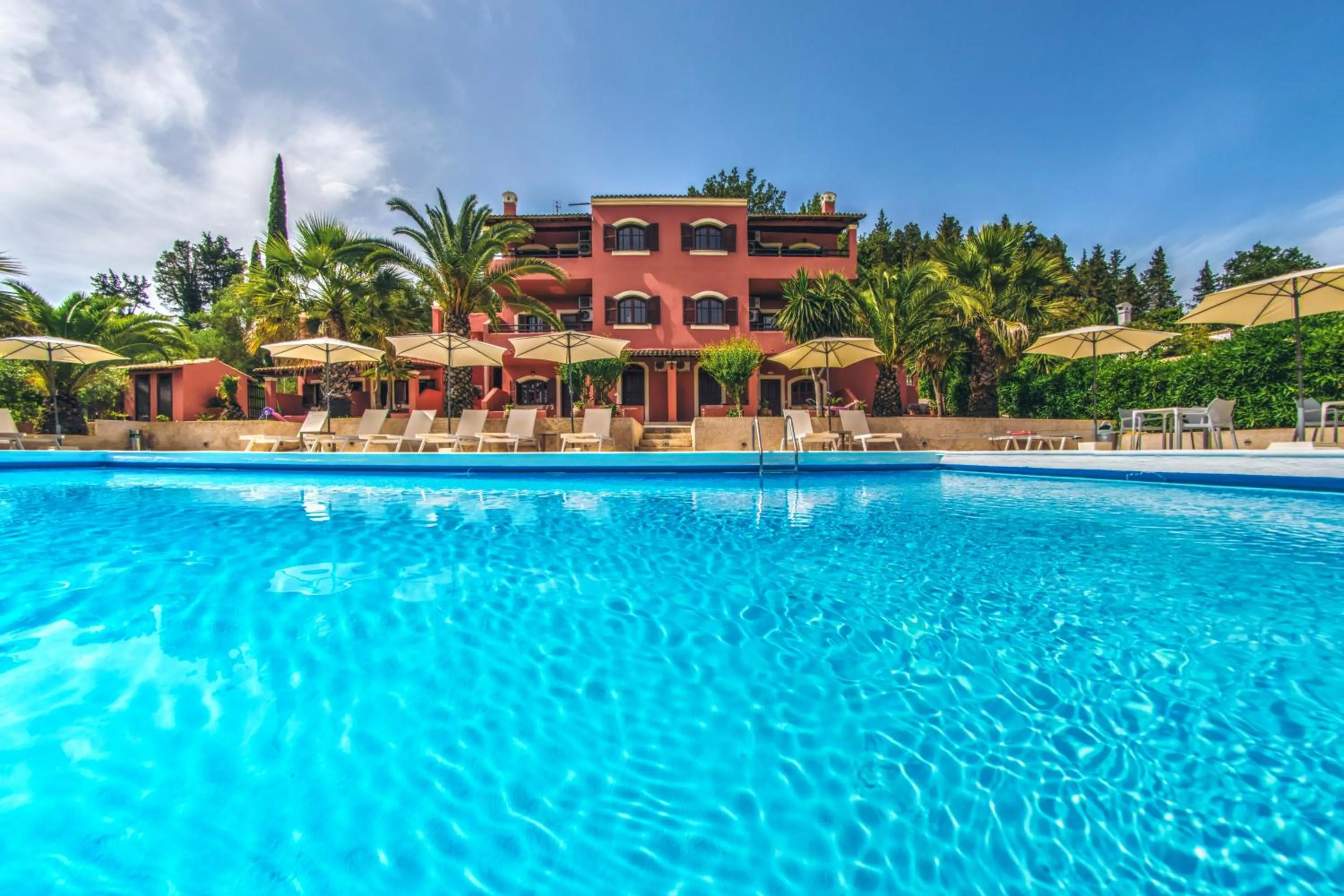 Property building in The Palm Garden - Idyllic Pool Apartments in a Green Oasis