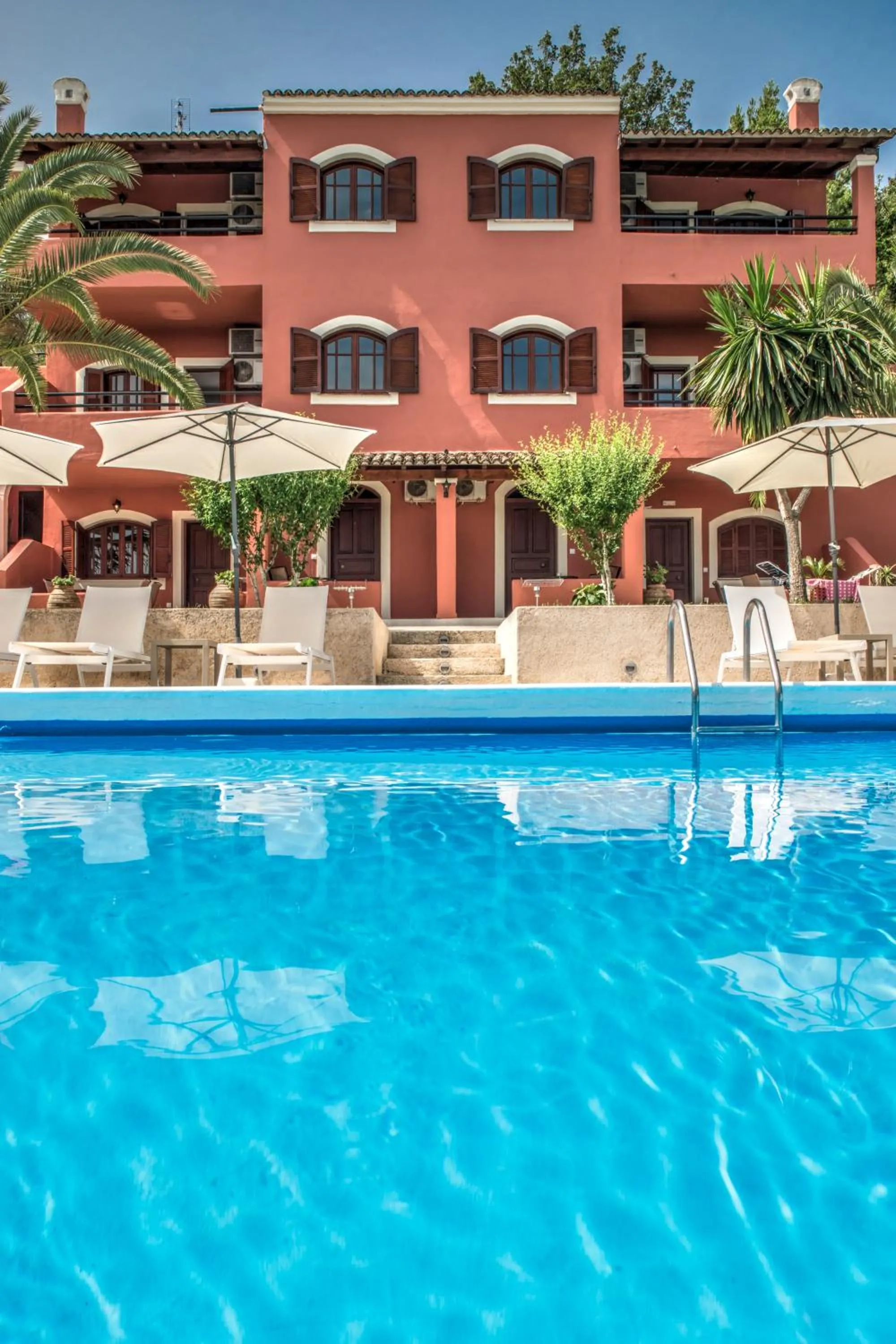 Property building in The Palm Garden - Idyllic Pool Apartments in a Green Oasis