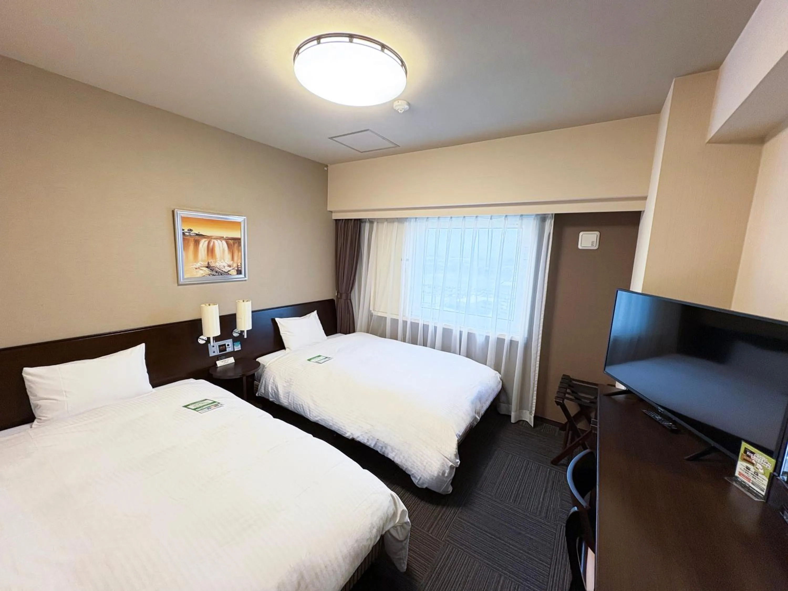 Photo of the whole room, Bed in Hotel Route-Inn Tsuruoka Ekimae