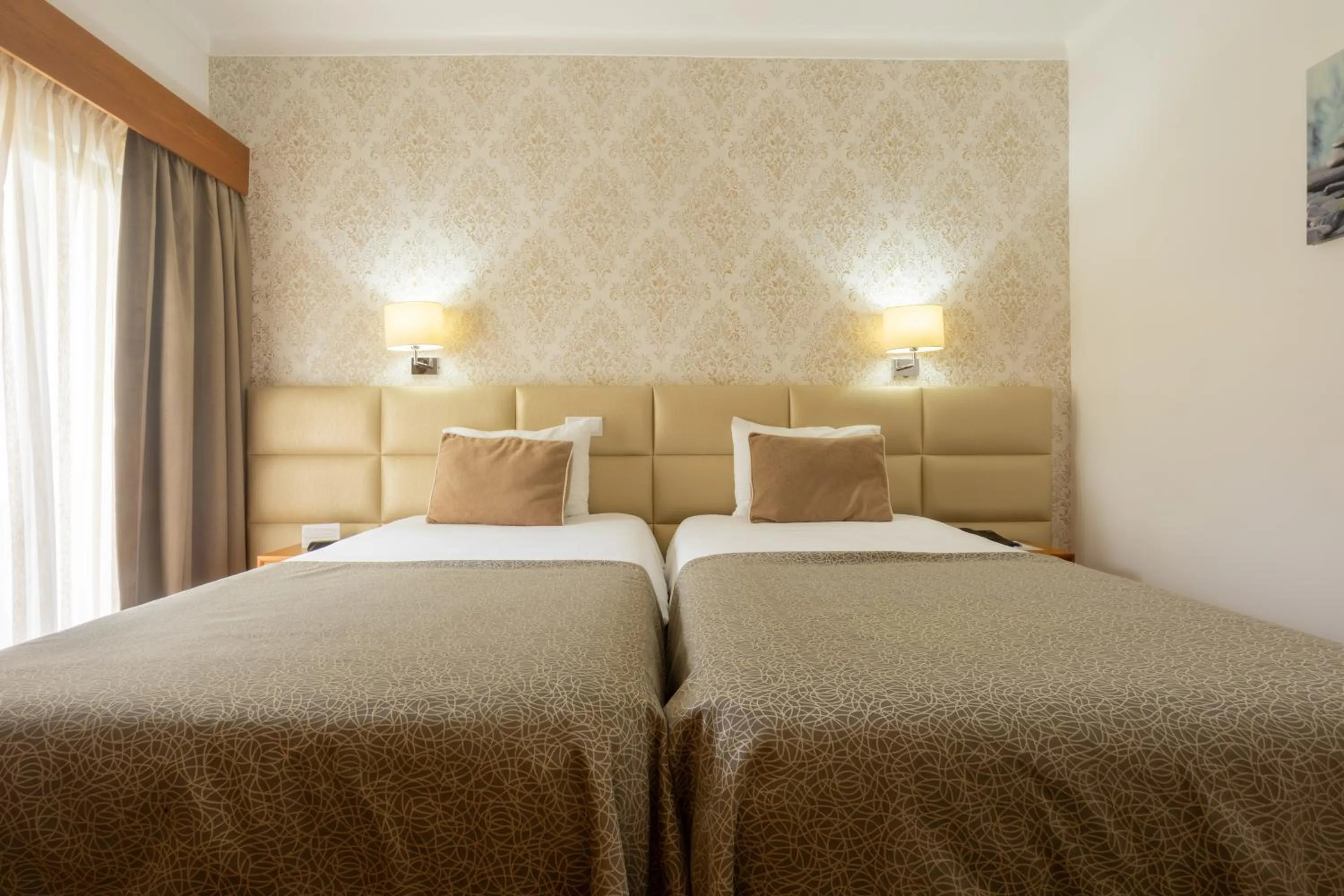 Bed in Hotel Sao Jorge Garden