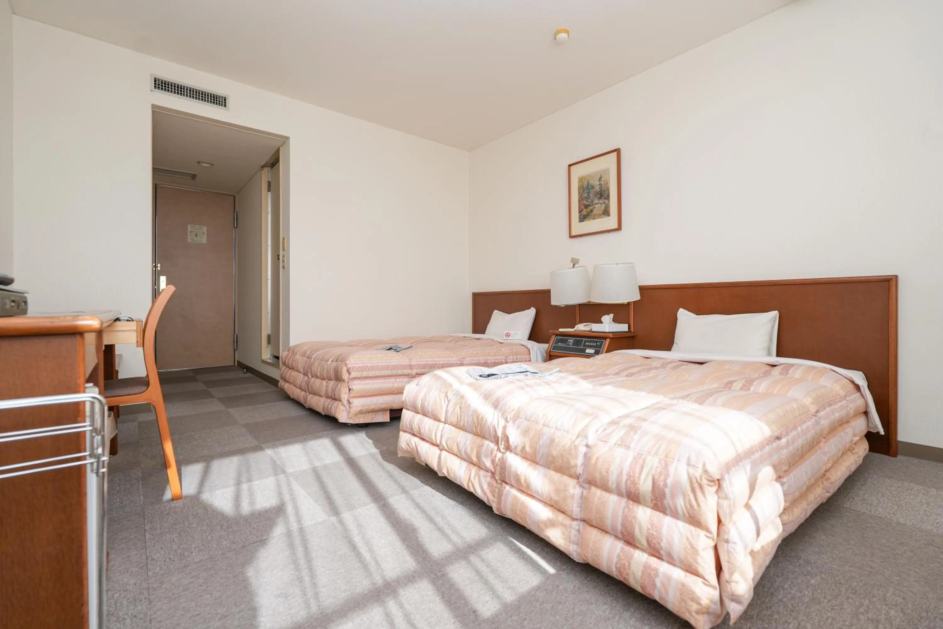 Bed in Tendo Central Hotel