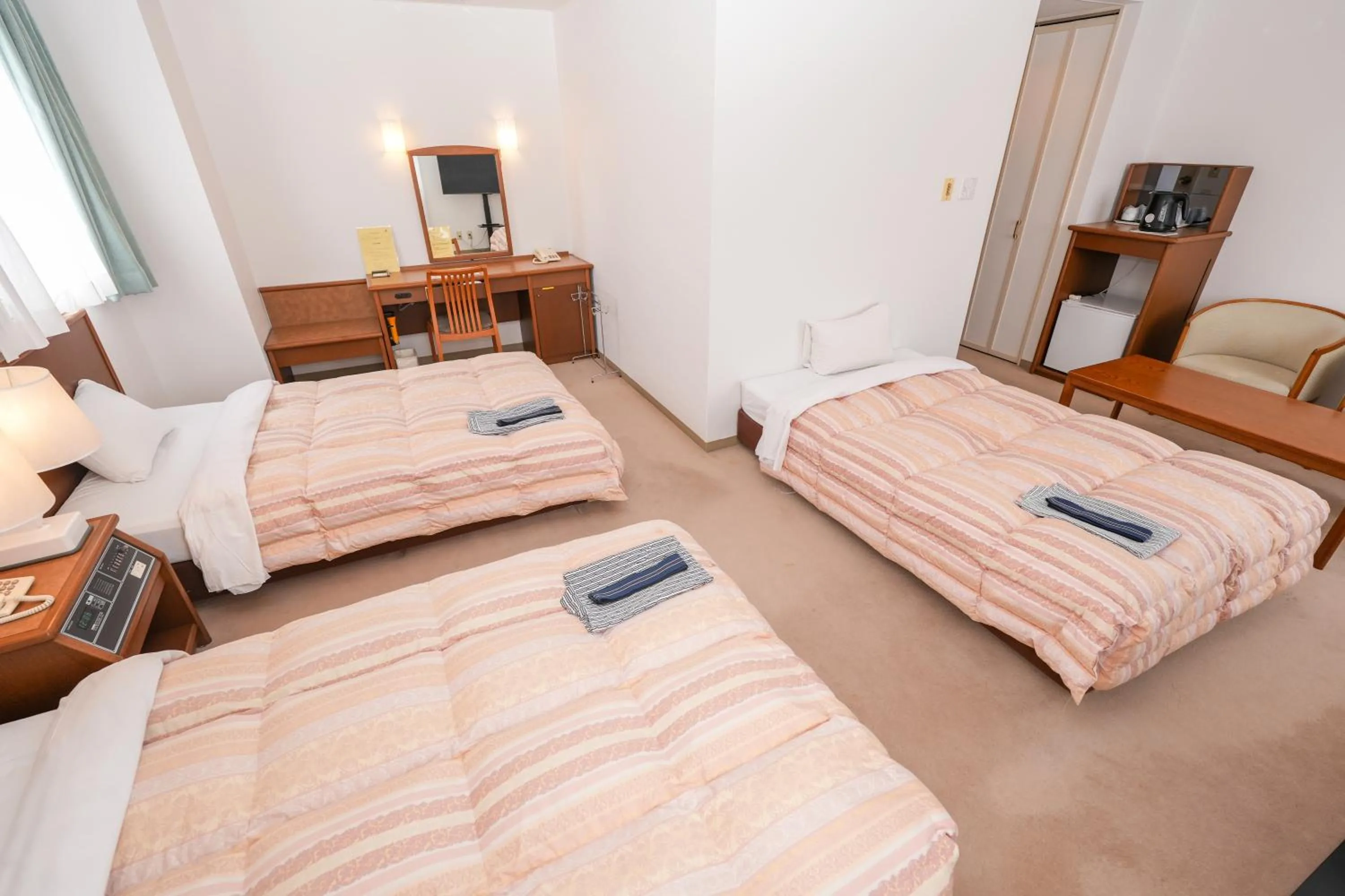 Bed in Tendo Central Hotel