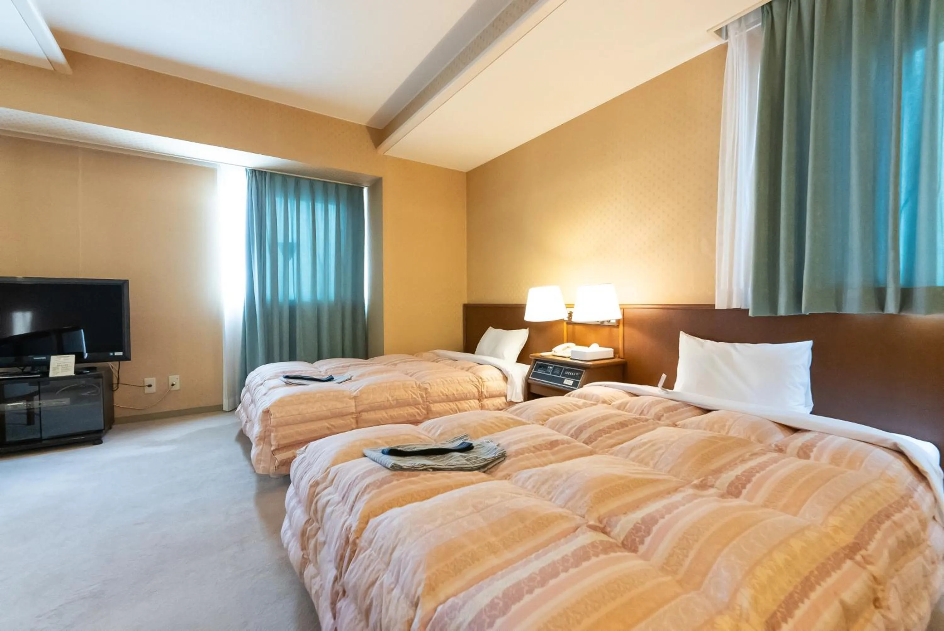 Bed in Tendo Central Hotel