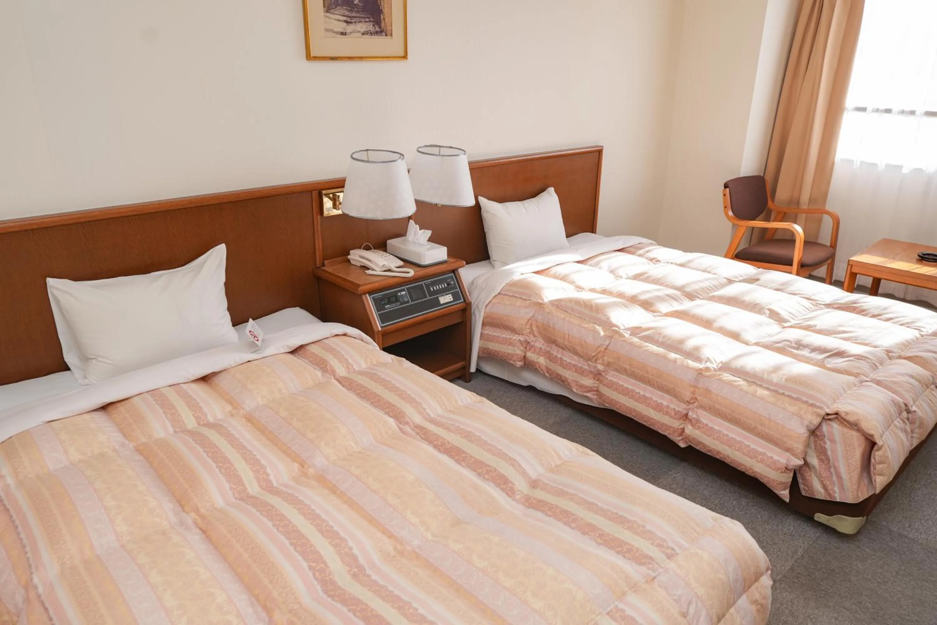 Bed in Tendo Central Hotel