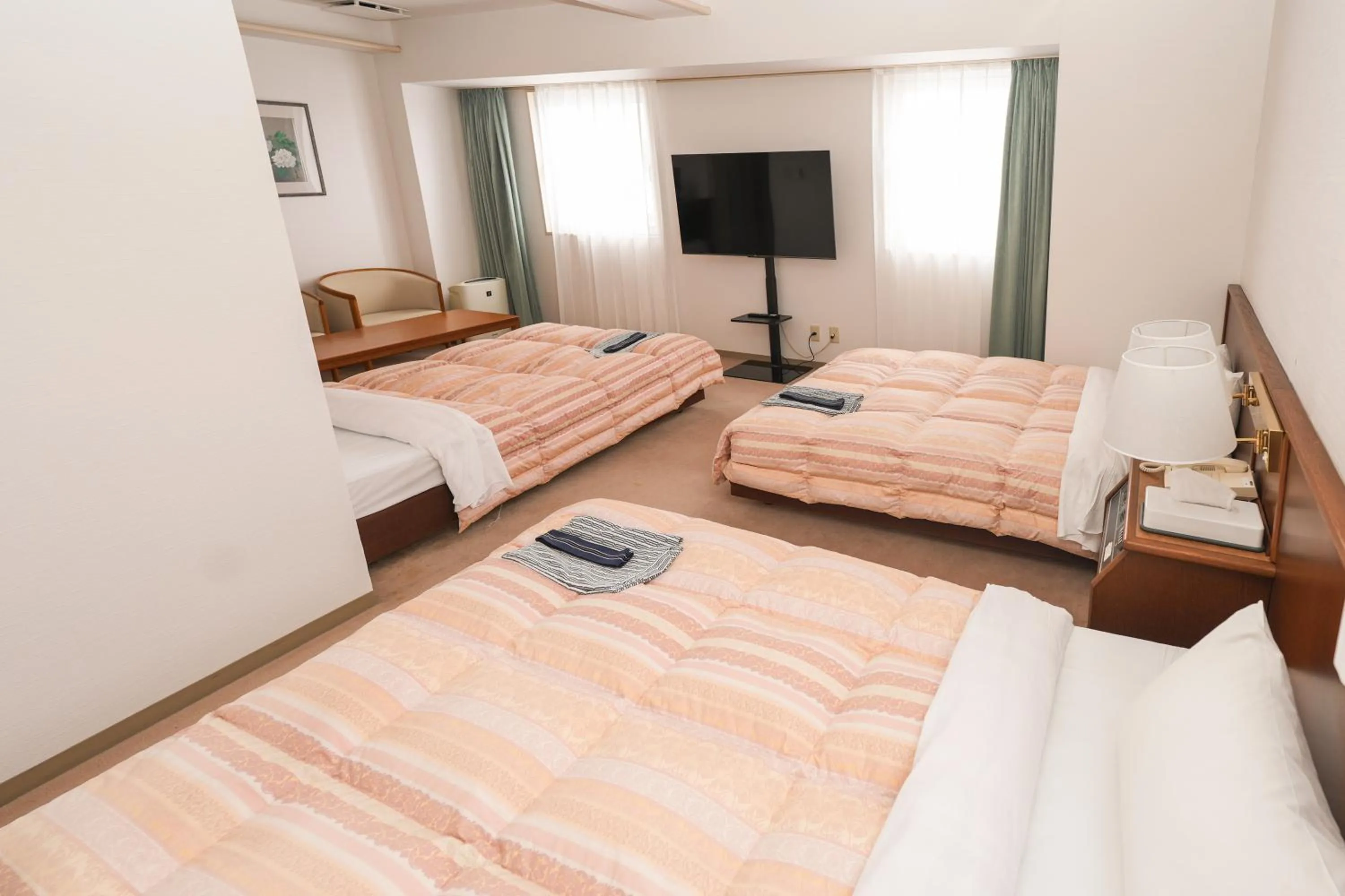 Bed in Tendo Central Hotel