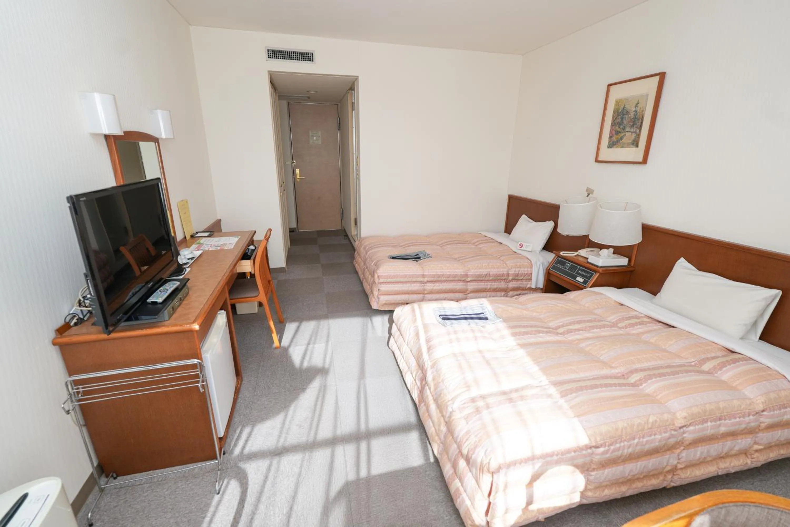 Bed in Tendo Central Hotel