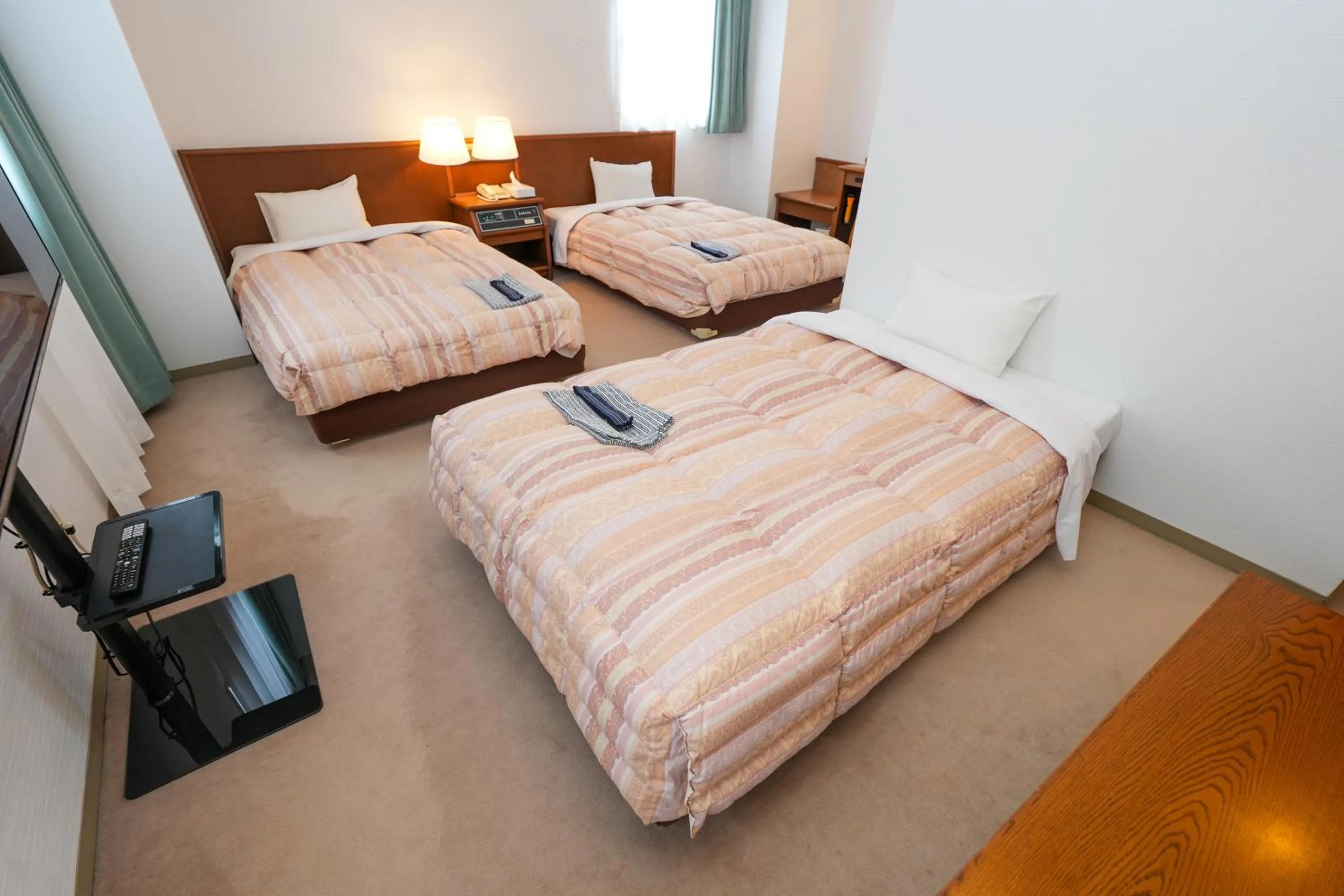 Bed in Tendo Central Hotel