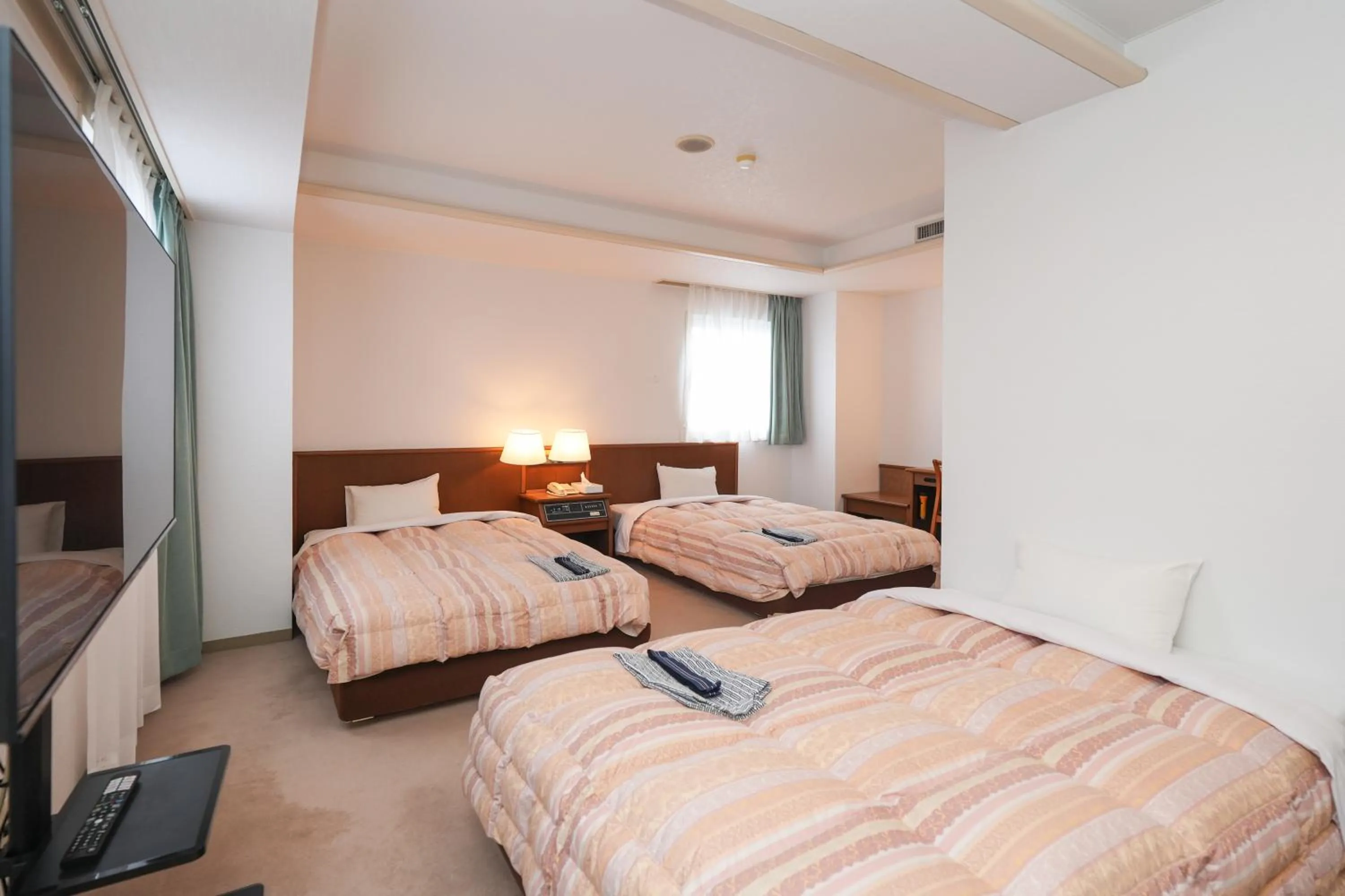 Bed in Tendo Central Hotel