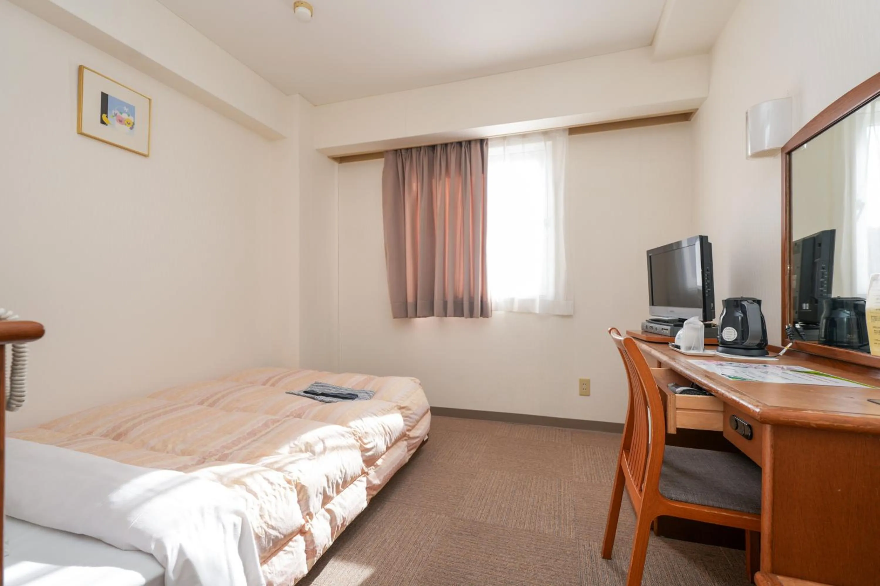 Bed in Tendo Central Hotel