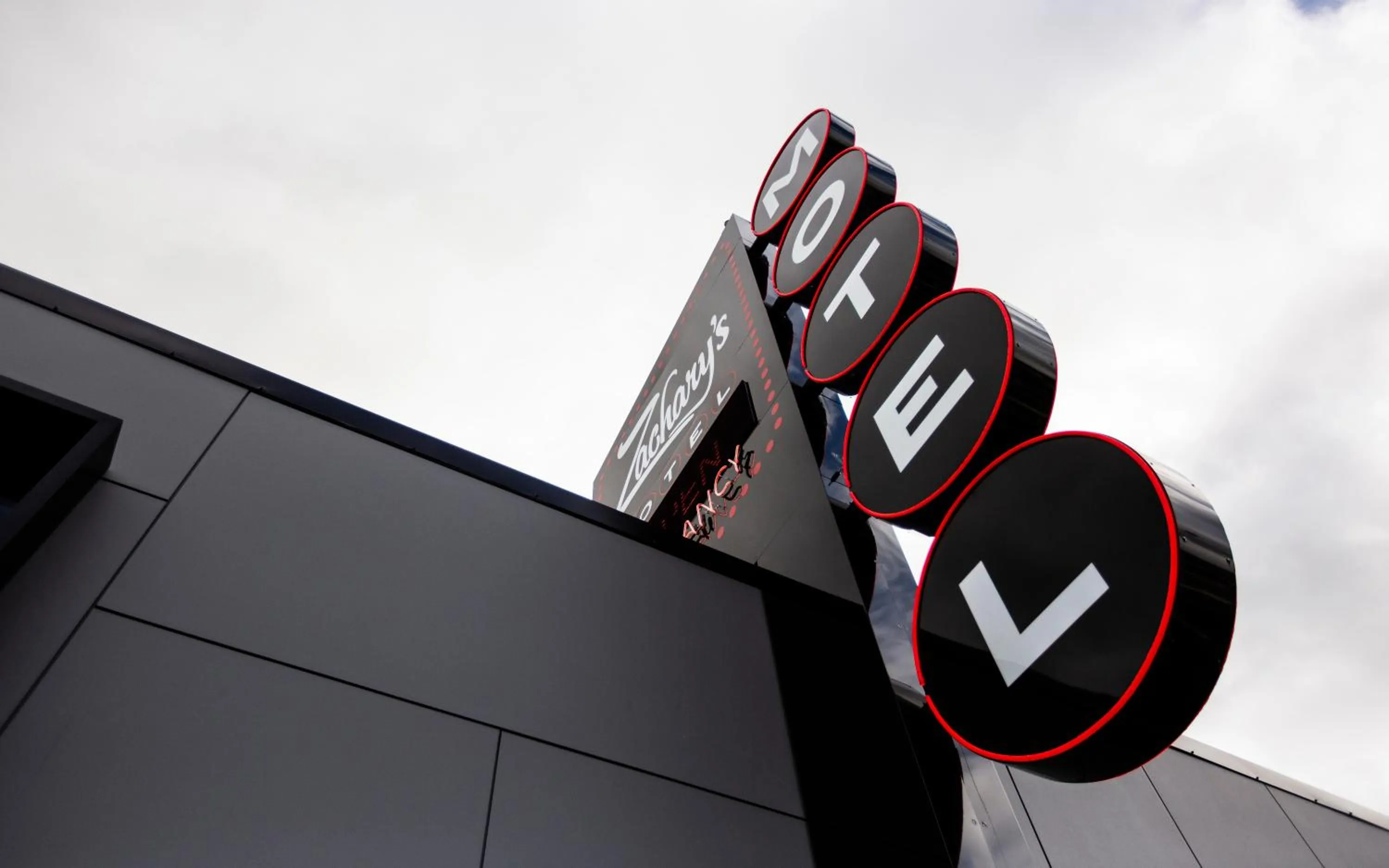 Property logo or sign in Zachary's Motel