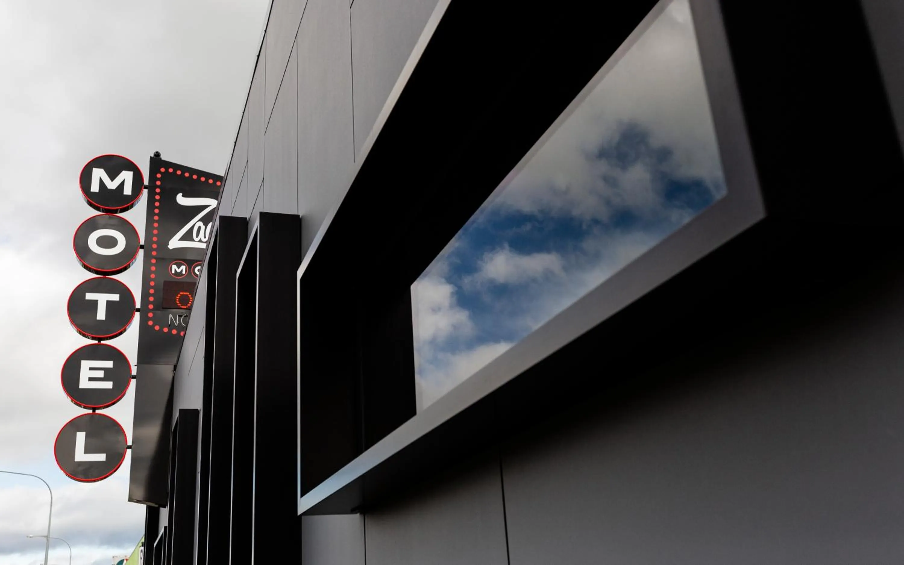 Property logo or sign in Zachary's Motel