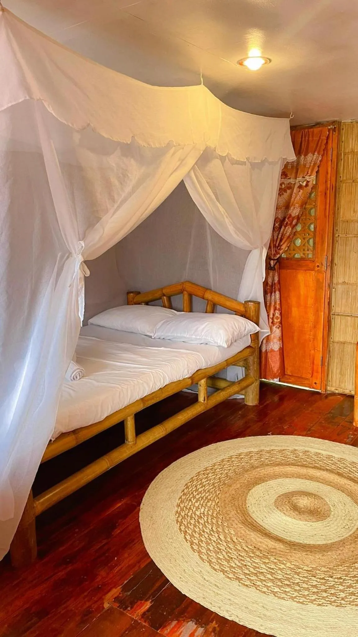 Bed in Camiguin Blue Lagoon Cottages