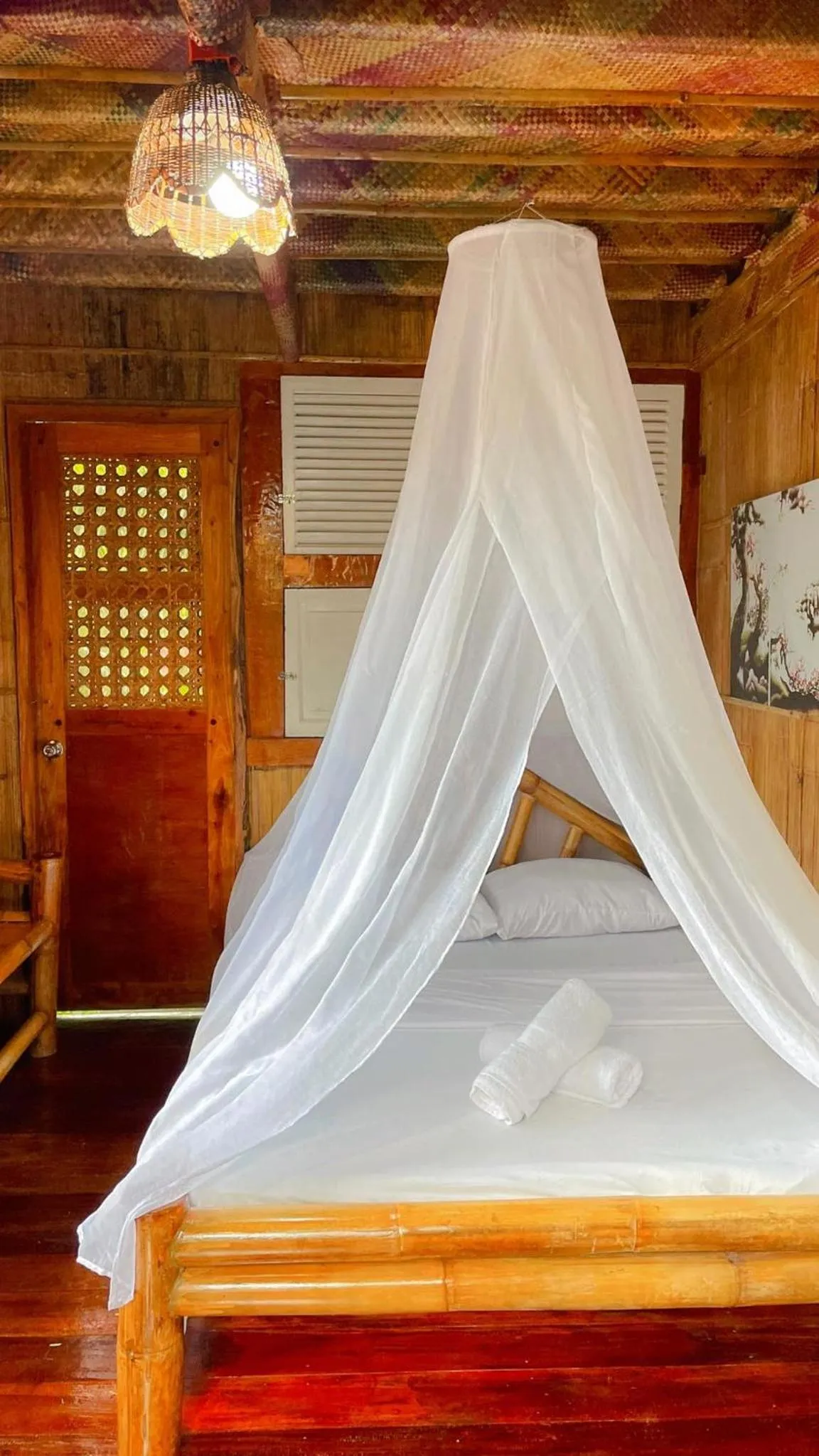 Bed in Camiguin Blue Lagoon Cottages