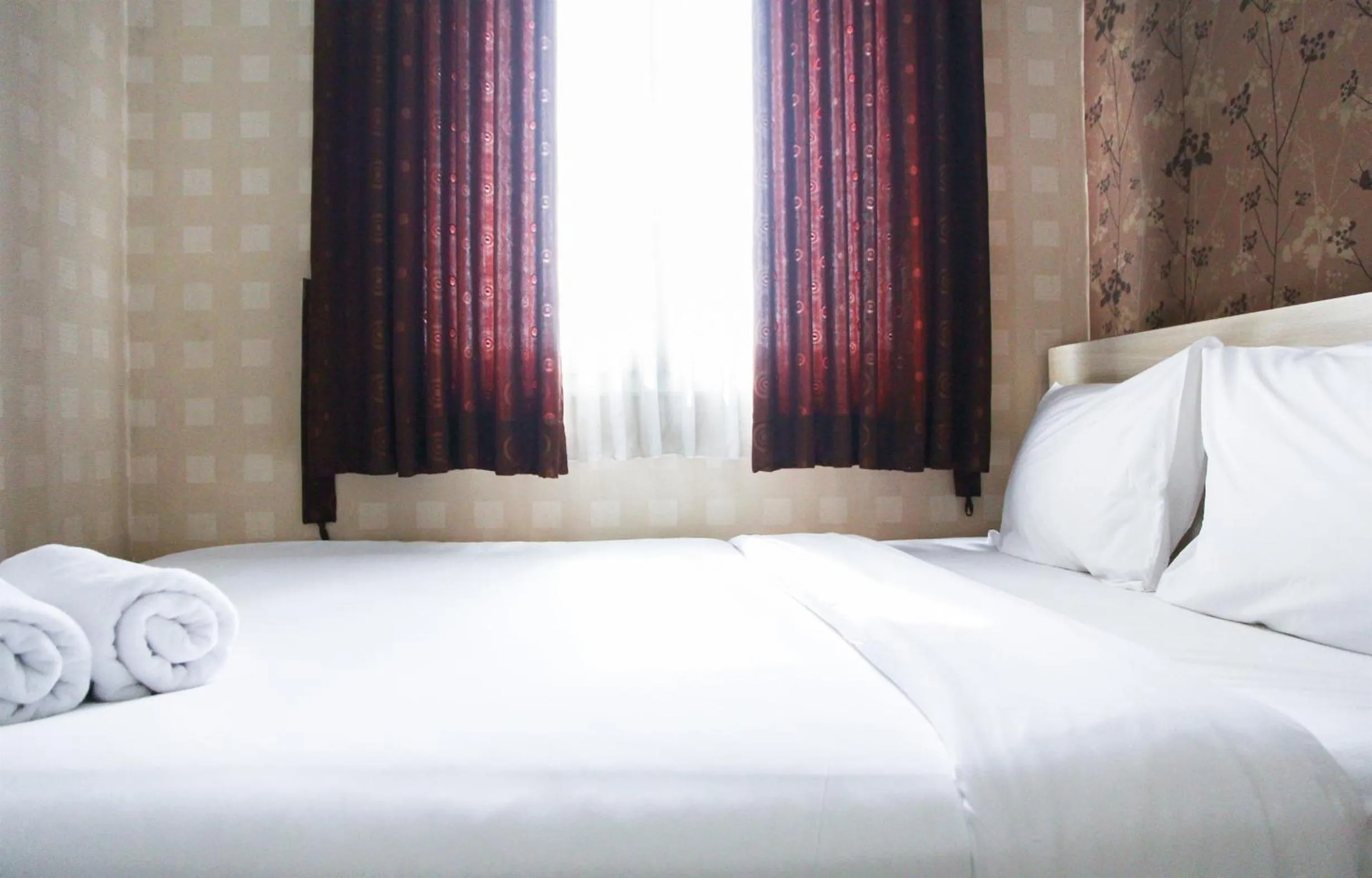 Bed in Pool View 2BR Mutiara Bekasi Apartment By Travelio