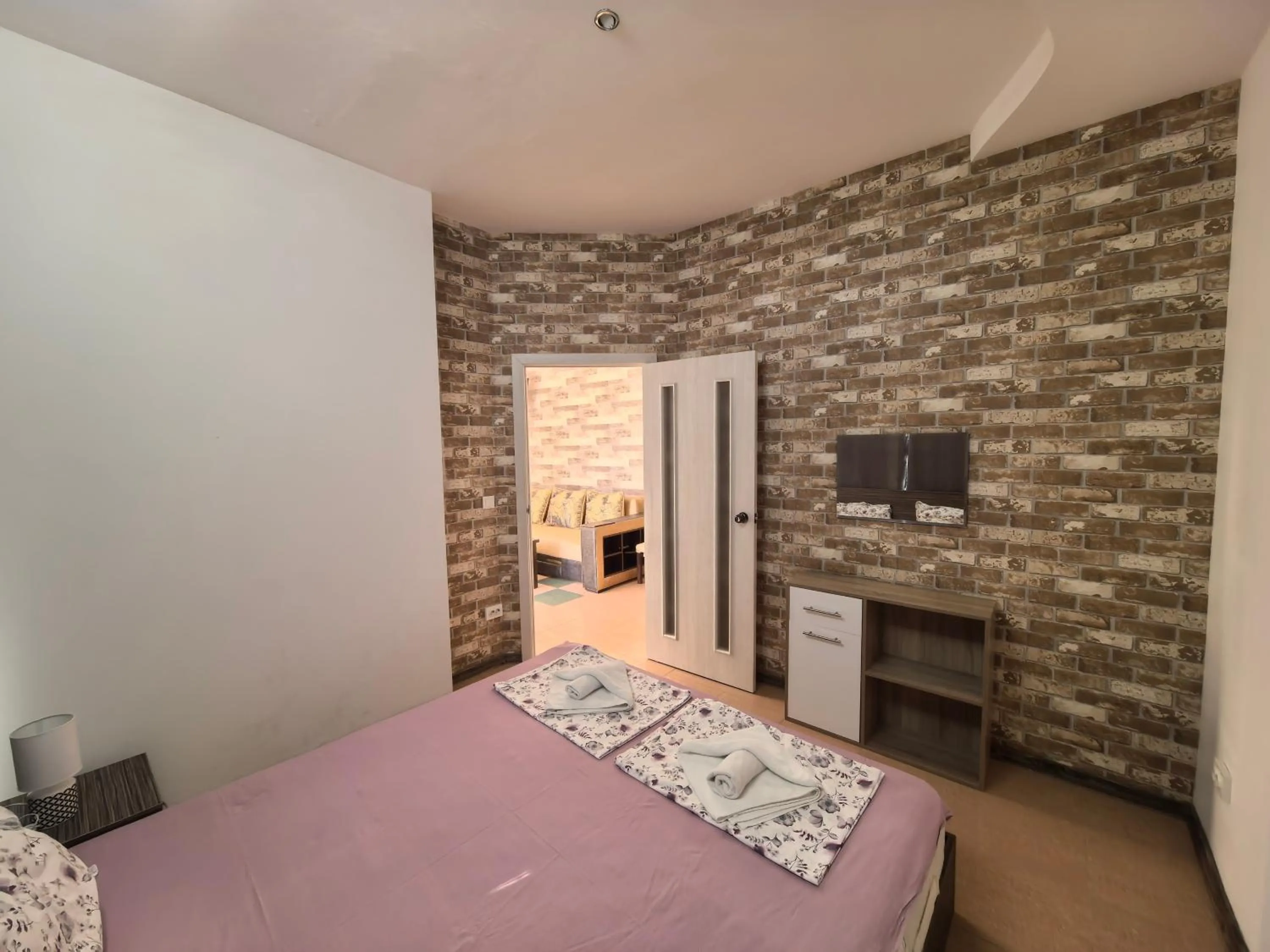 Bed in Rose Garden Omax Apartments