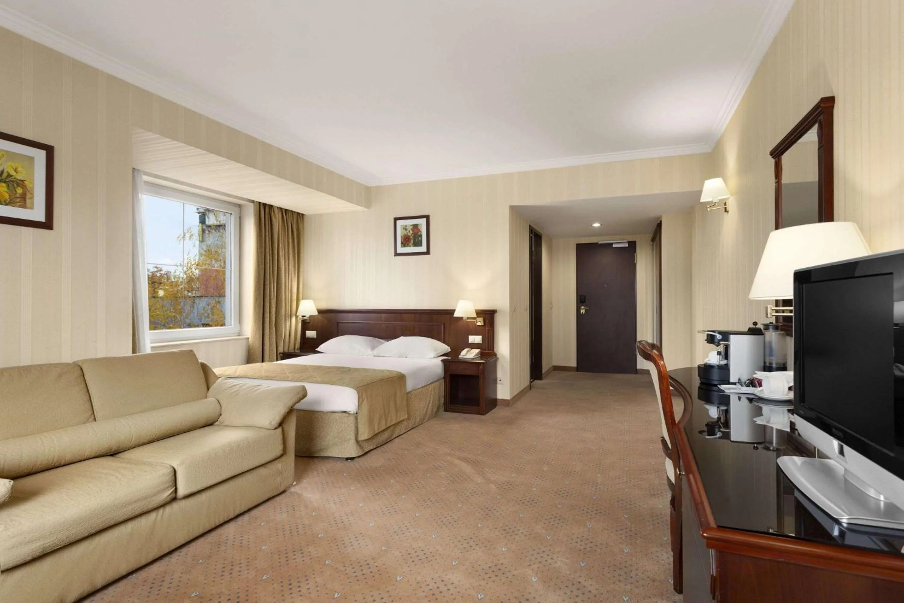 Photo of the whole room, Bed in Ramada Hotel & Suites by Wyndham Bucharest North