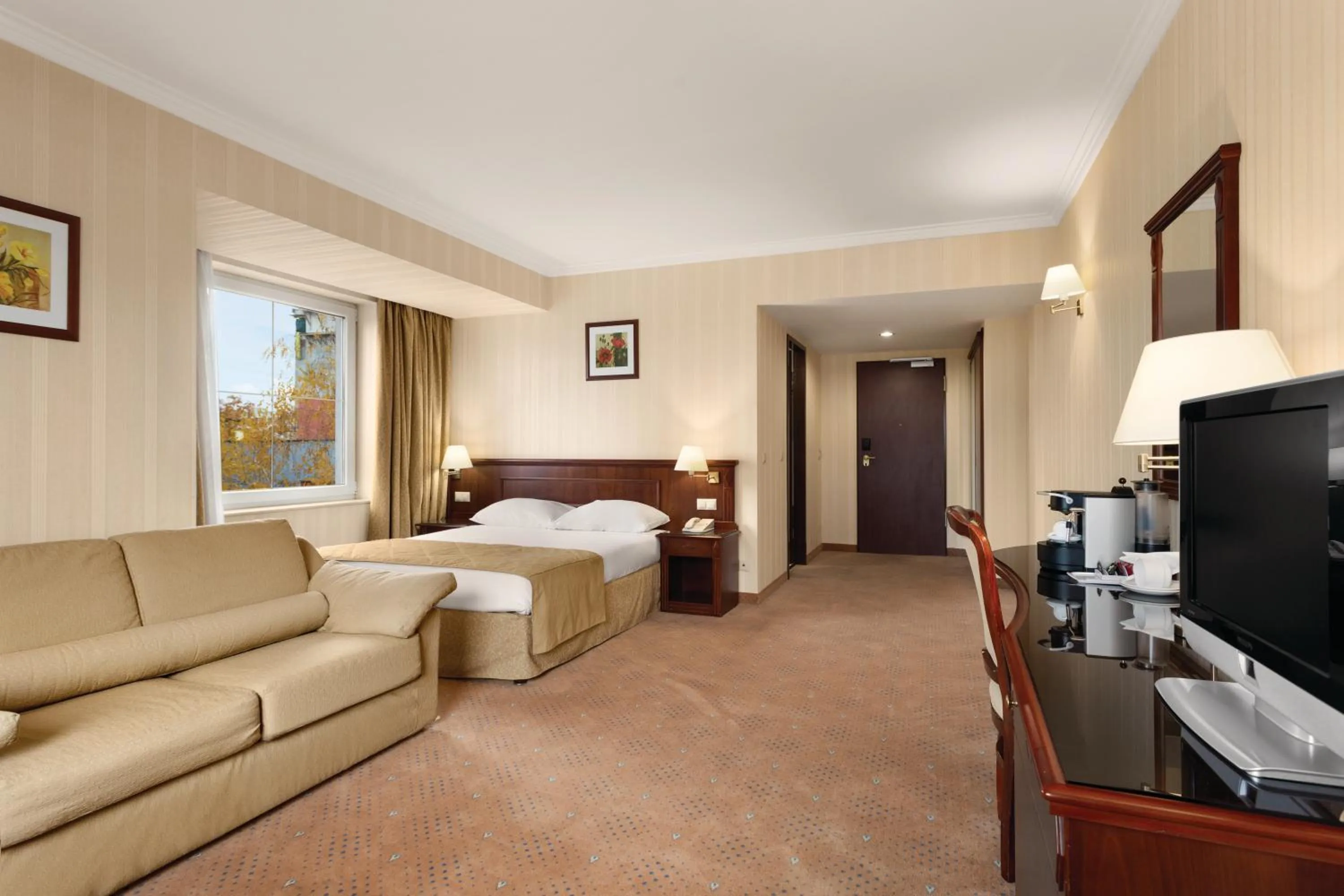 Photo of the whole room, Bed in Ramada Hotel & Suites by Wyndham Bucharest North
