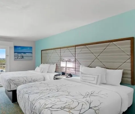 Bed in NEW 2026-Ocean Sands Beach Boutique Inn-Sauna and Salt-Mineral Pool -Free Beach Bikes and Famous Beach- Fresh Baked Cookies and Popcorn - Bathrobes and Sunscreen in all rooms-Ultra Sparkling-Free Laundry- 4 Grand Black Beds-Call NOW & Save-1-252-AHA-SAND