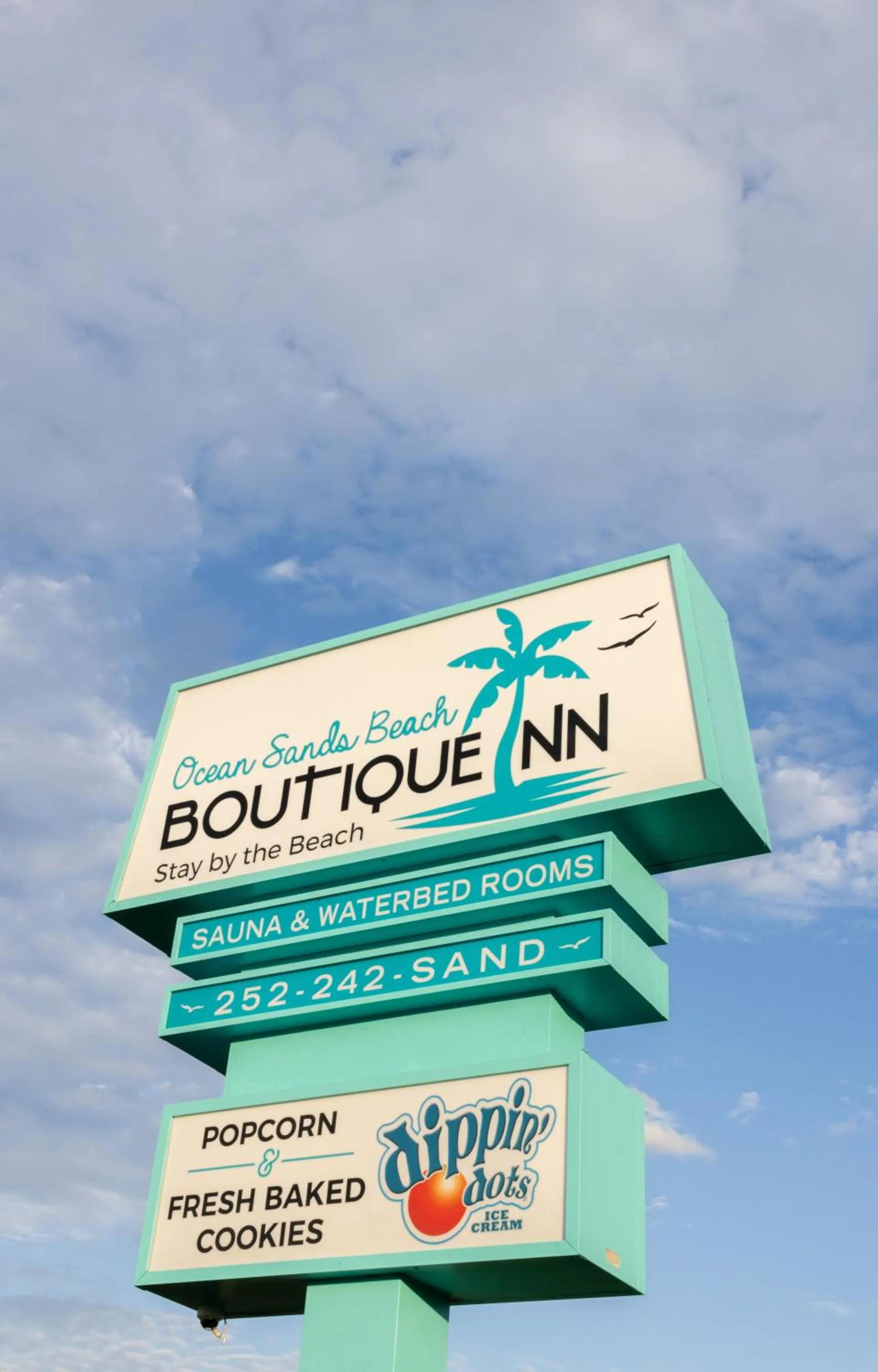 Property building in NEW 2026-Ocean Sands Beach Boutique Inn-Sauna and Salt-Mineral Pool -Free Beach Bikes and Famous Beach- Fresh Baked Cookies and Popcorn - Bathrobes and Sunscreen in all rooms-Ultra Sparkling-Free Laundry- 4 Grand Black Beds-Call NOW & Save-1-252-AHA-SAND