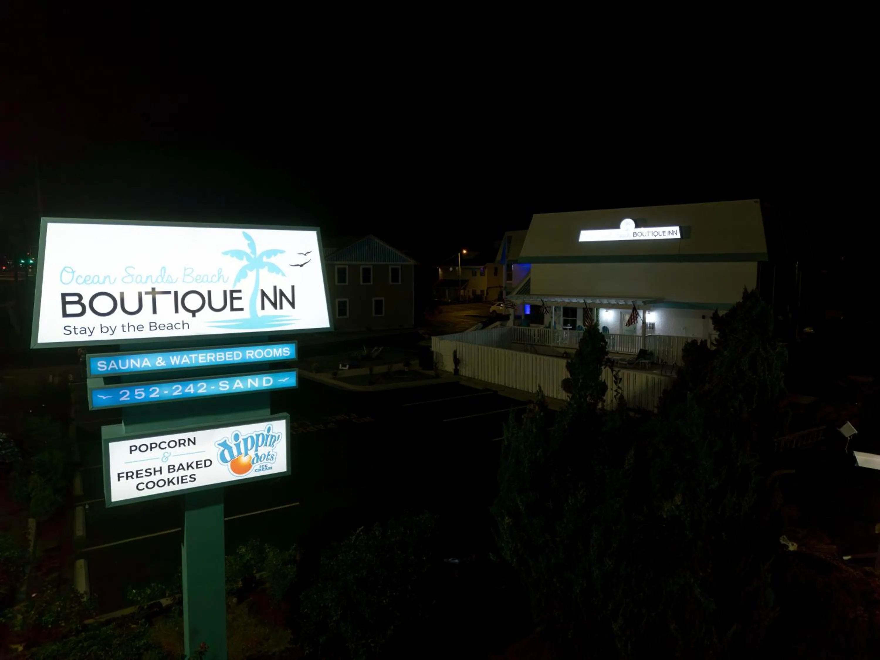 Property building in NEW 2026-Ocean Sands Beach Boutique Inn-Sauna and Salt-Mineral Pool -Free Beach Bikes and Famous Beach- Fresh Baked Cookies and Popcorn - Bathrobes and Sunscreen in all rooms-Ultra Sparkling-Free Laundry- 4 Grand Black Beds-Call NOW & Save-1-252-AHA-SAND