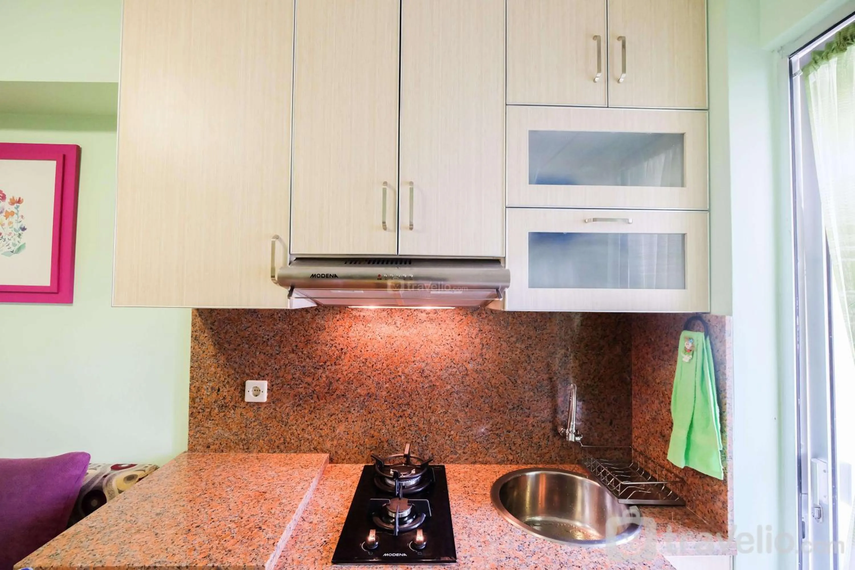 Kitchen or kitchenette in Cozy 2BR Bassura City Apartment By Travelio