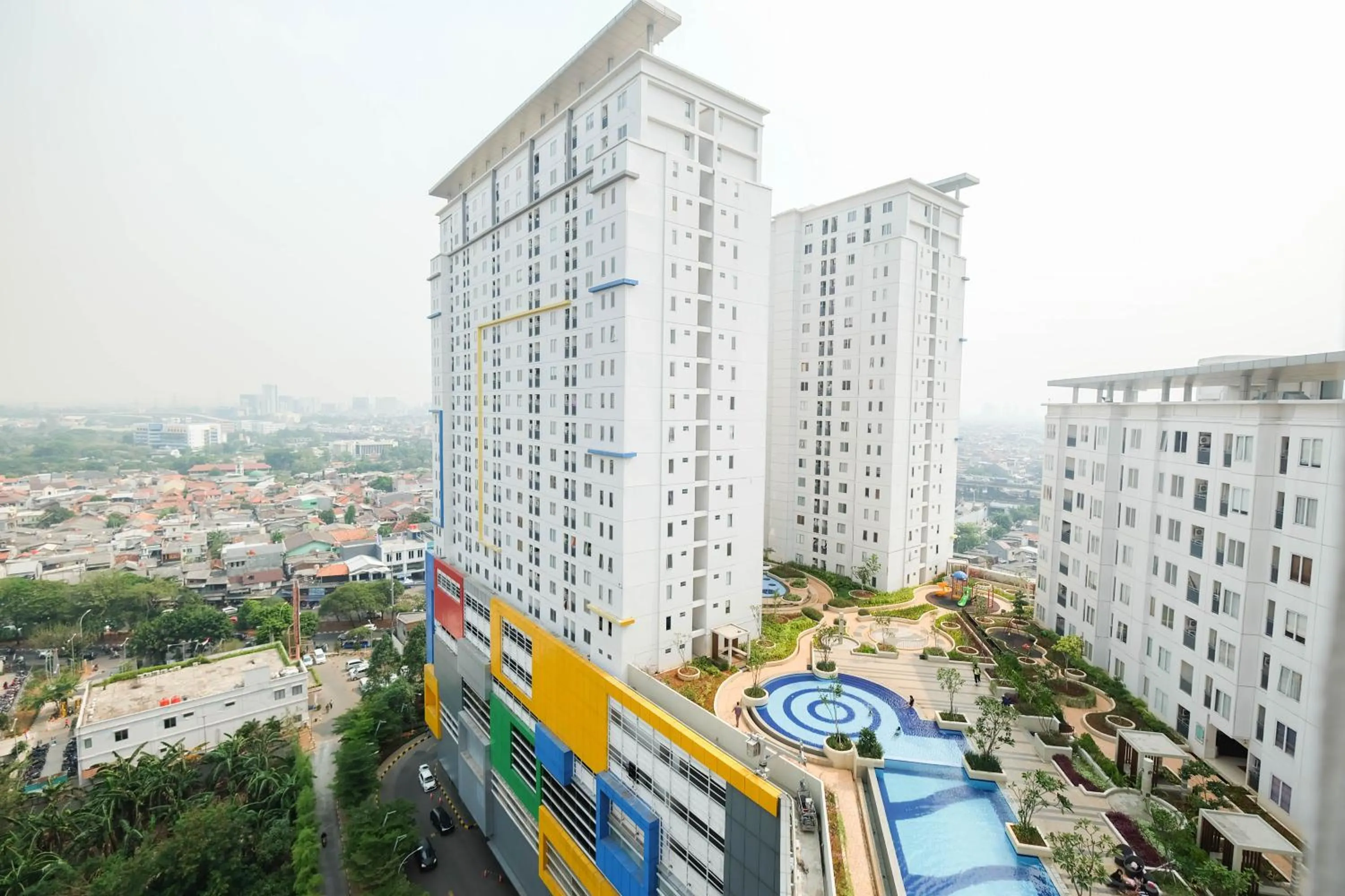 Property building in Cozy 2BR Bassura City Apartment By Travelio