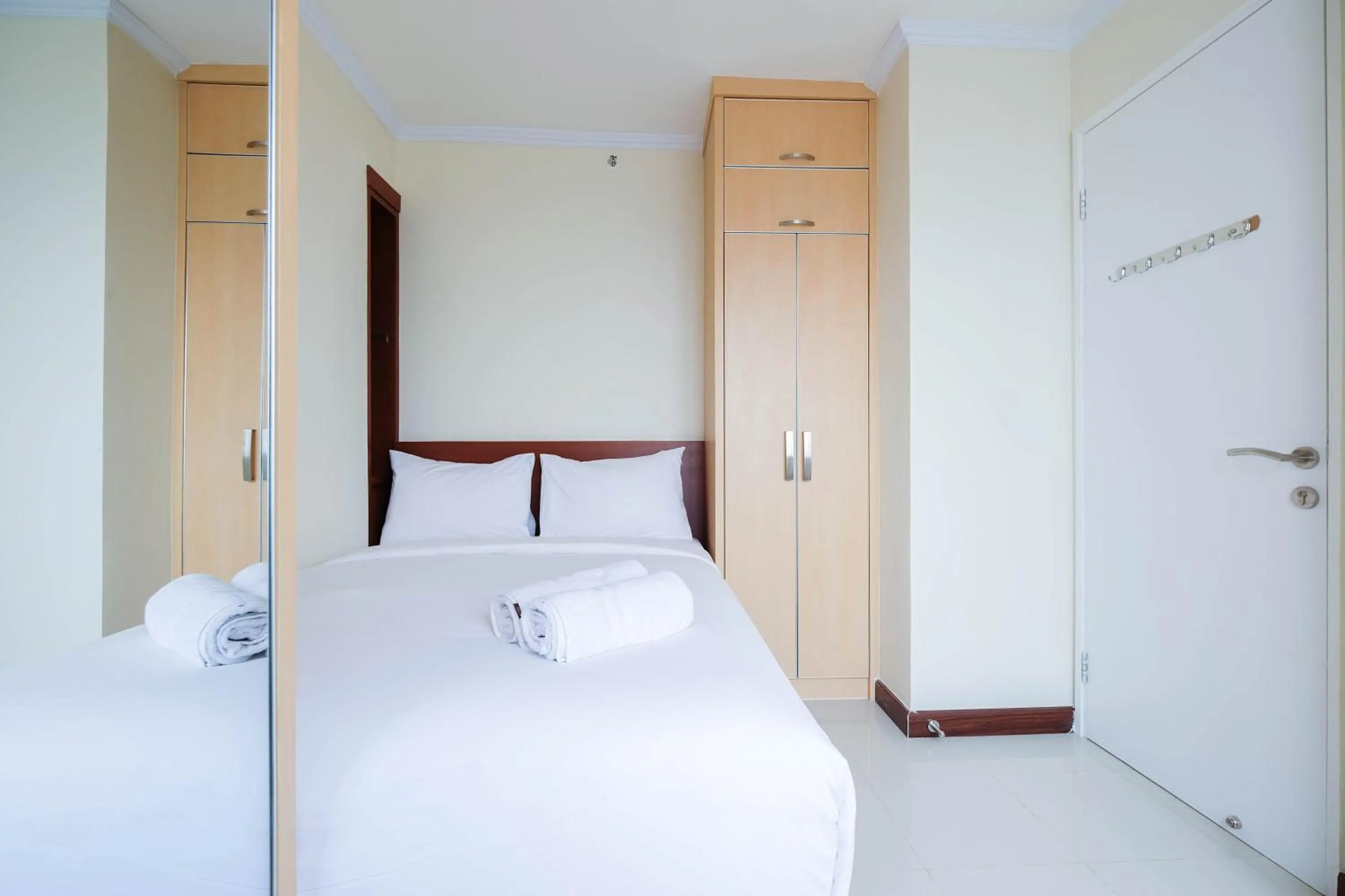 Bed in Cozy 2BR Bassura City Apartment By Travelio