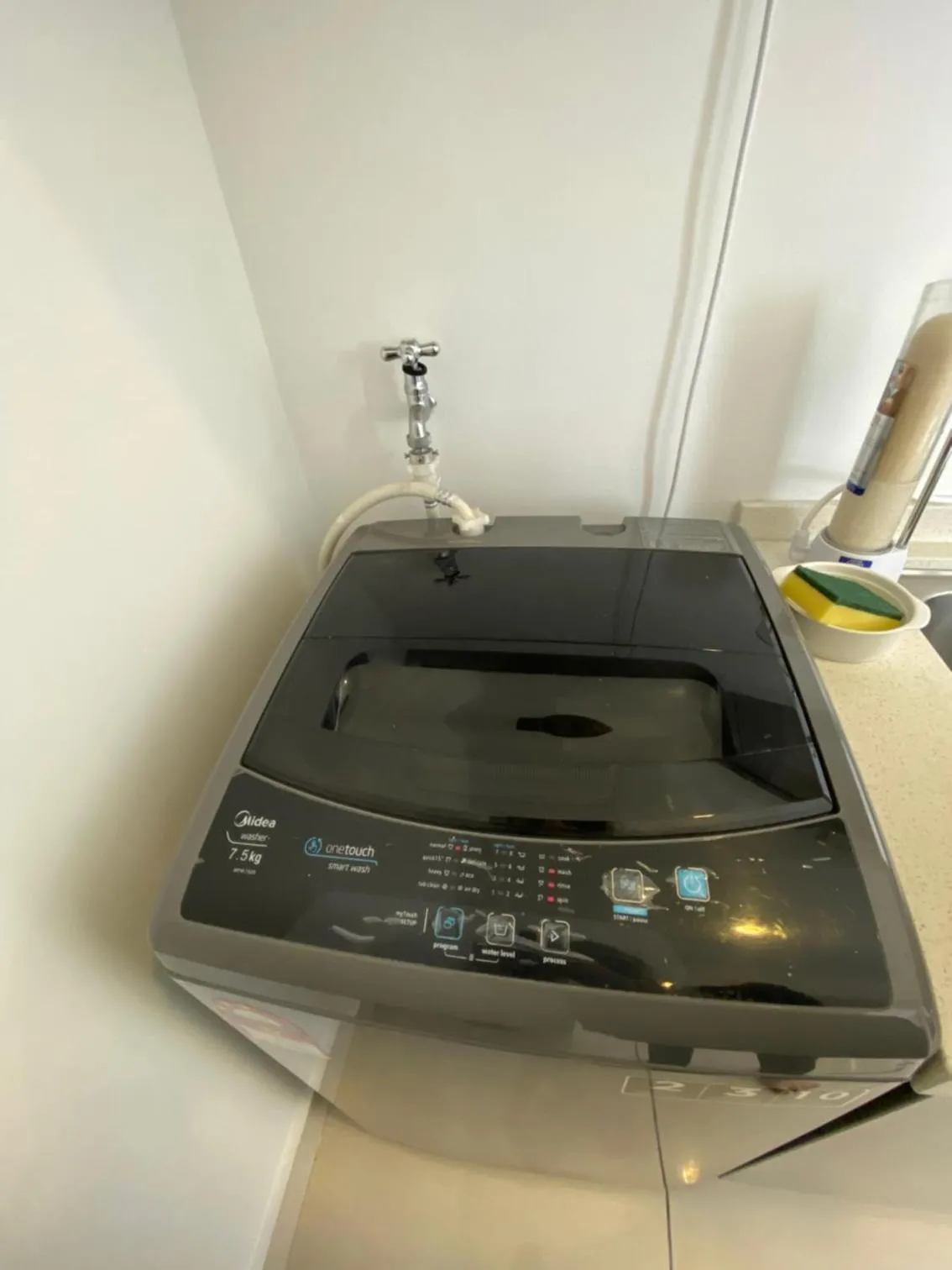 washing machine in Mansion One by Sky Hive