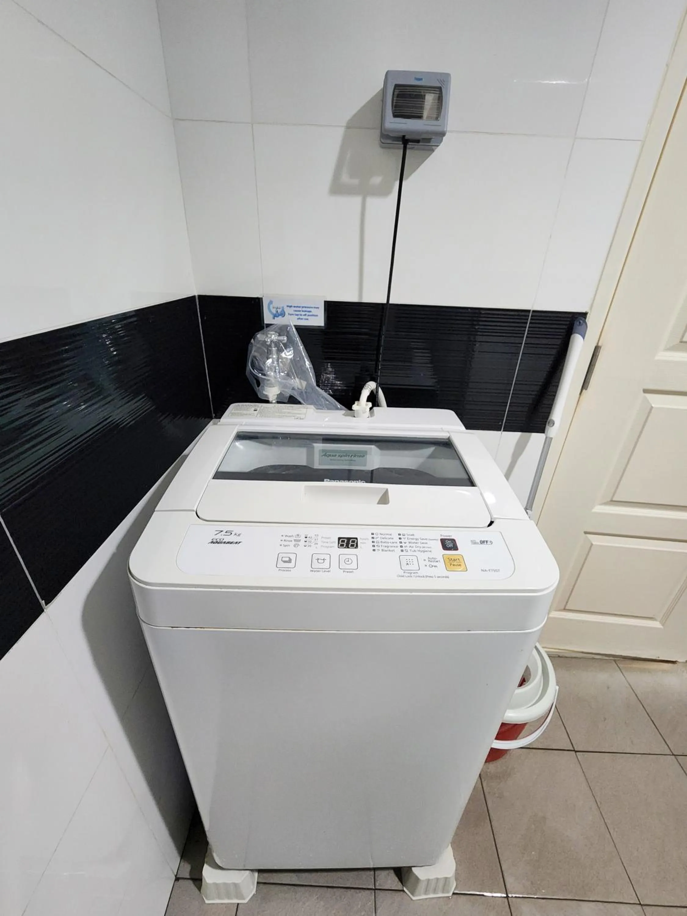washing machine in Mansion One by Sky Hive