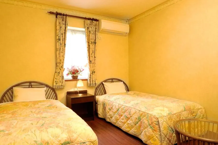 Bed in Petit Resort Hotel Alcyon