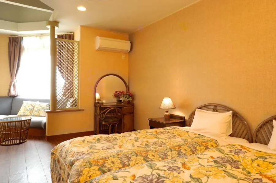 Bed in Petit Resort Hotel Alcyon