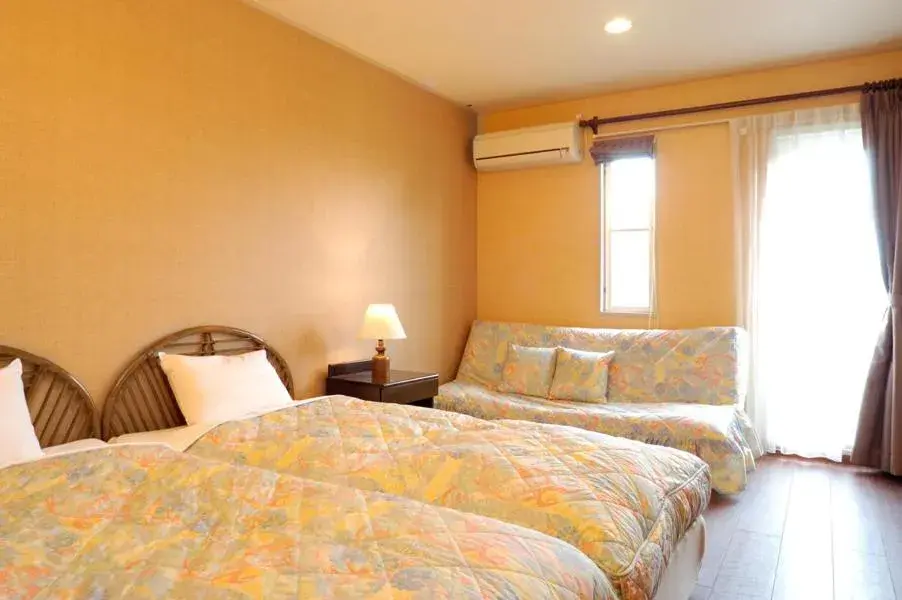 Bed in Petit Resort Hotel Alcyon Bed in Petit Resort Hotel Alcyon