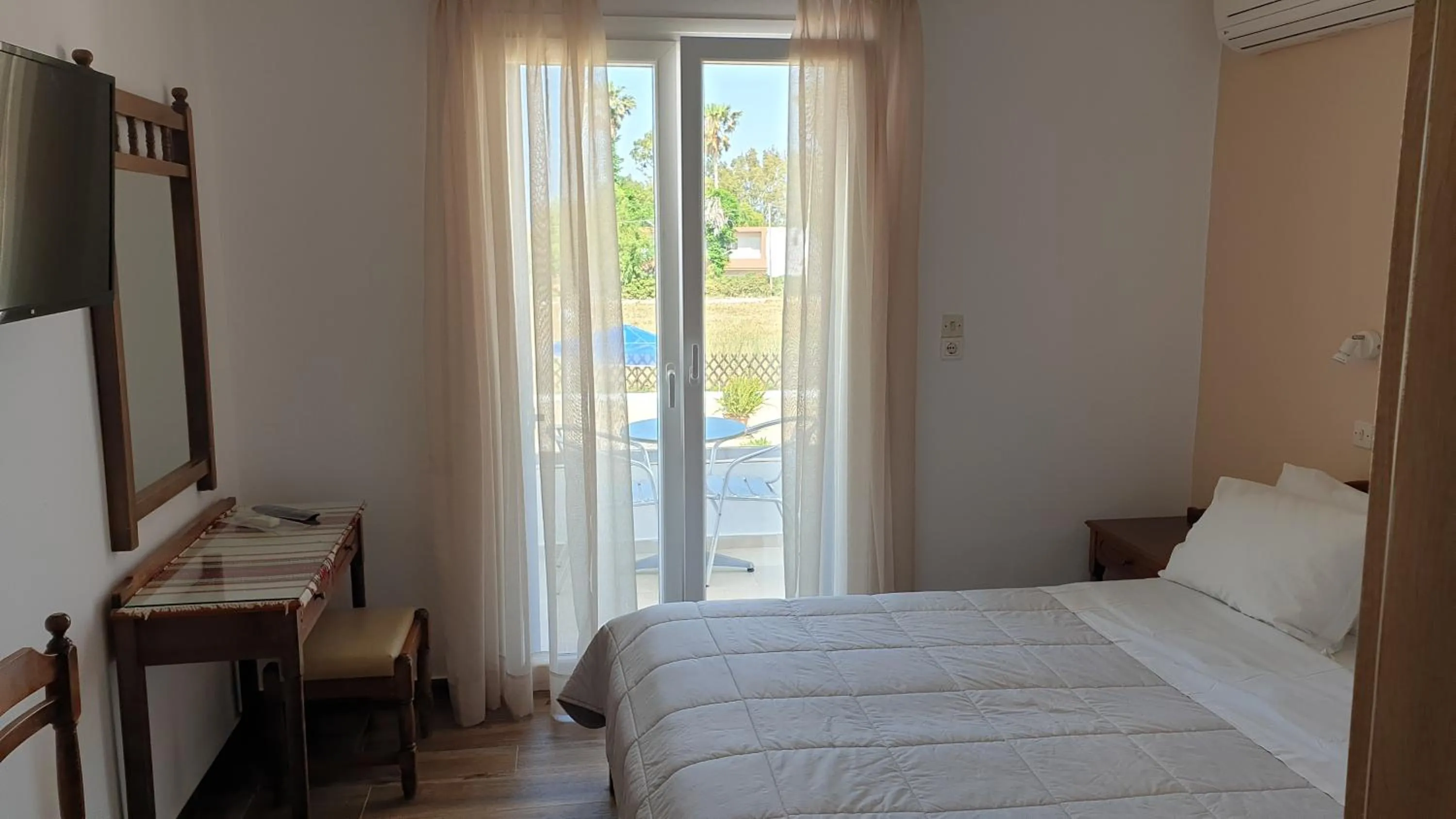 Bed in Miros Hotel Apartments