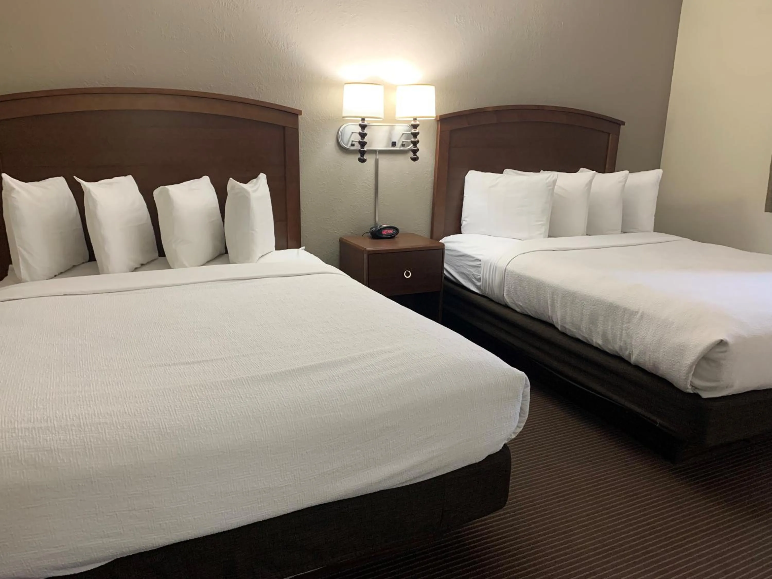 Bed in AmericInn by Wyndham Ironwood