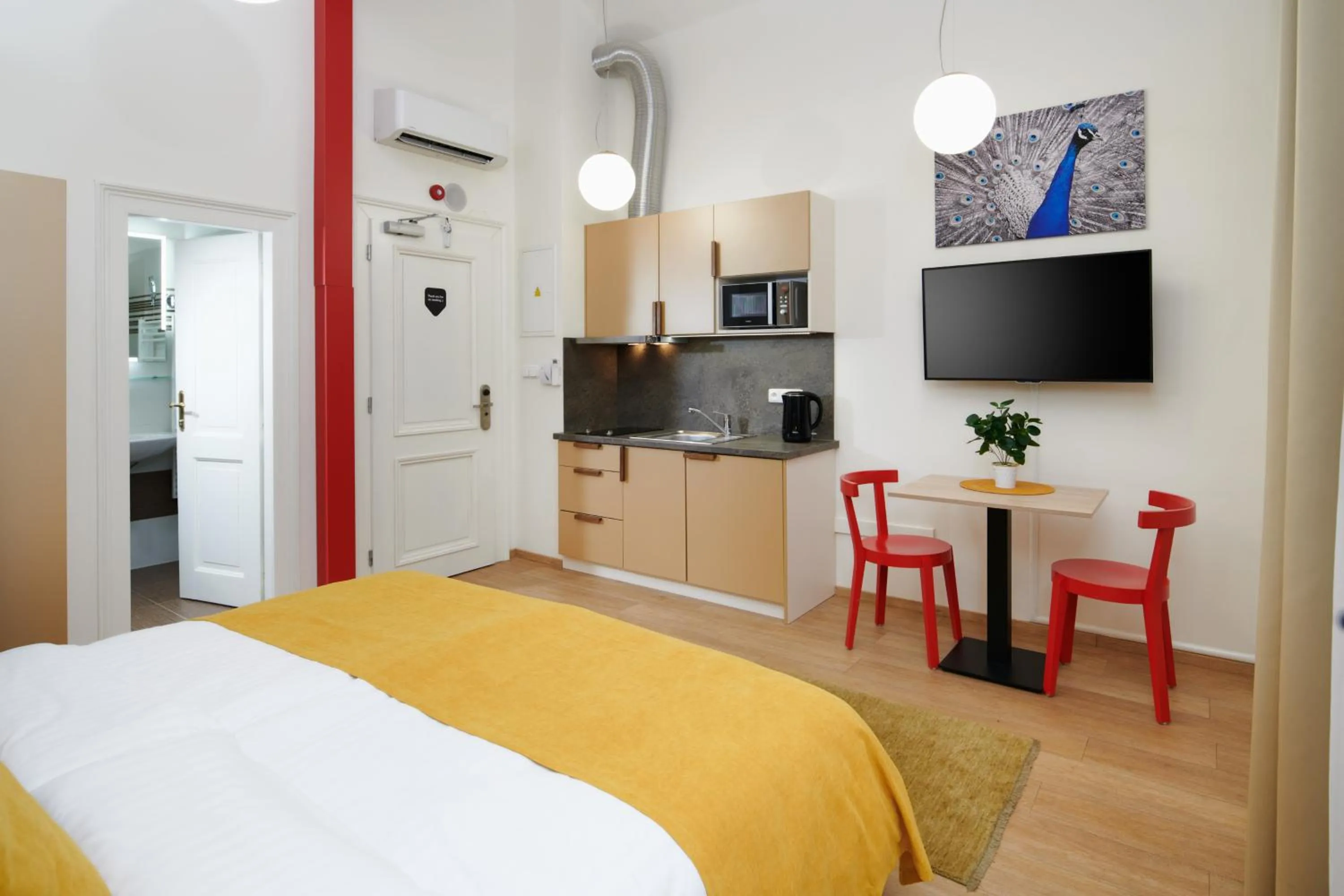 Dining area, Bed in City Nest Apartments by Adrez