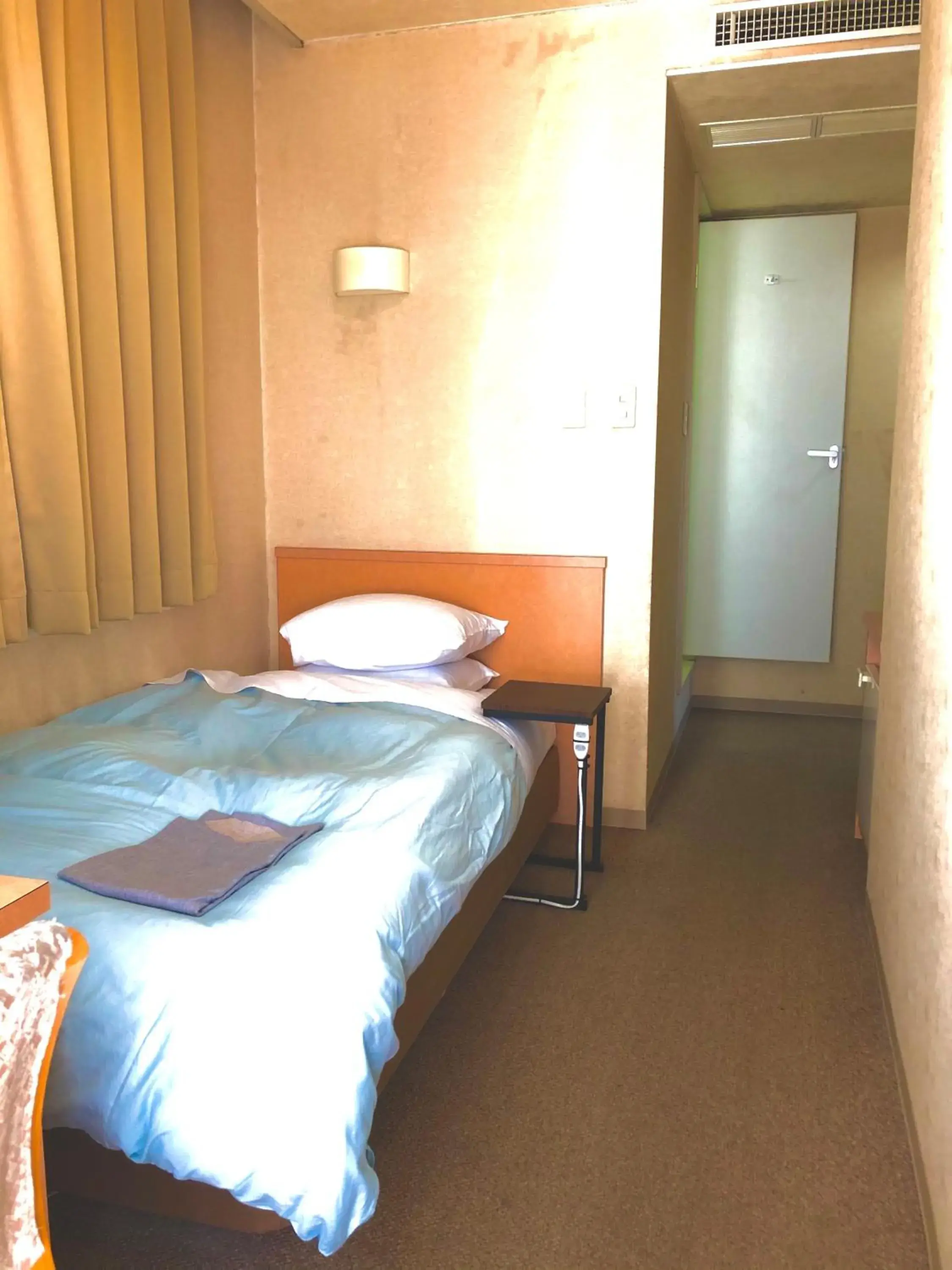 Bed in Asahi City Inn Hotel