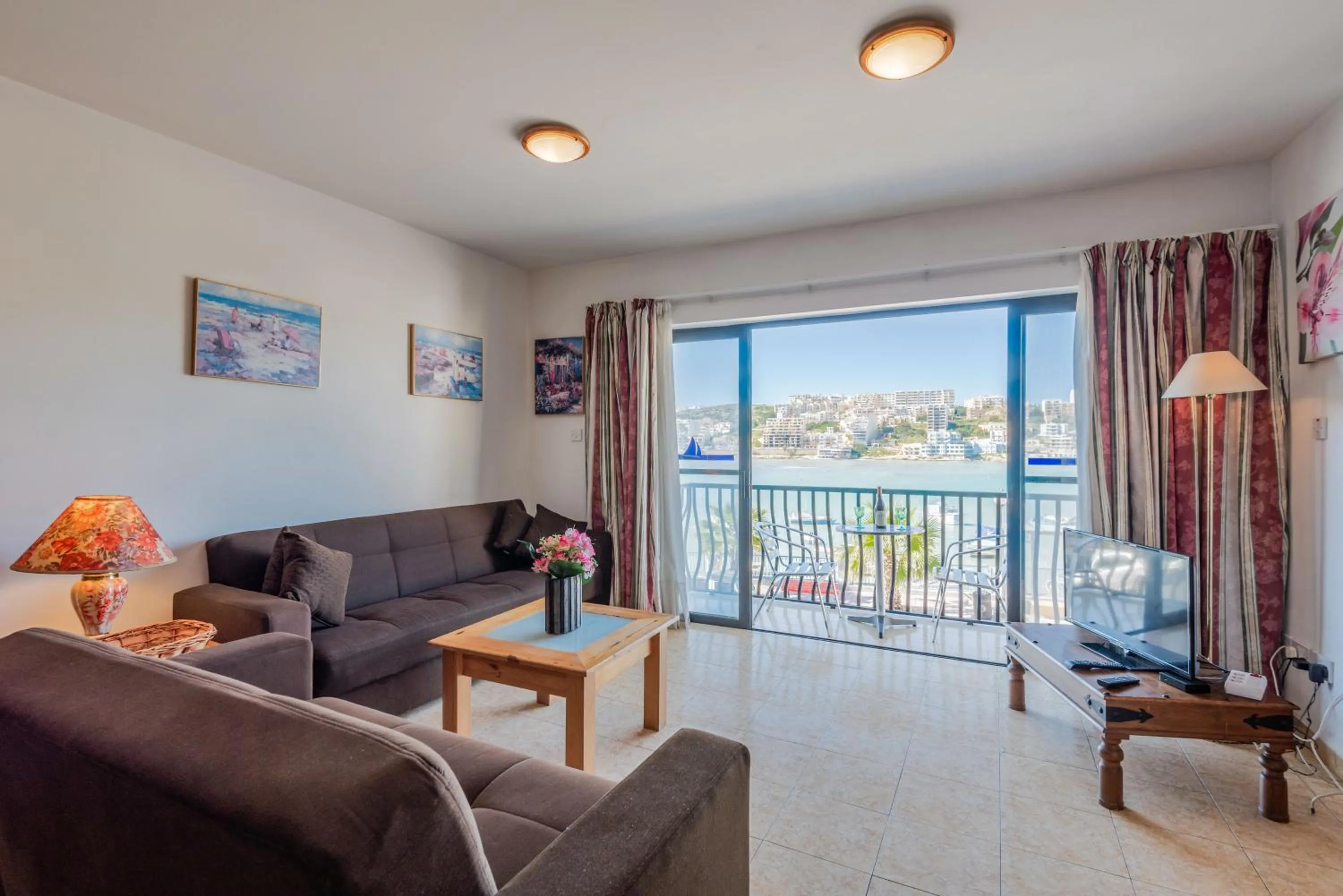 Living room in Harbour Lights seafront 2 bedroom apartments with panoramic sea views - by Getawaysmalta