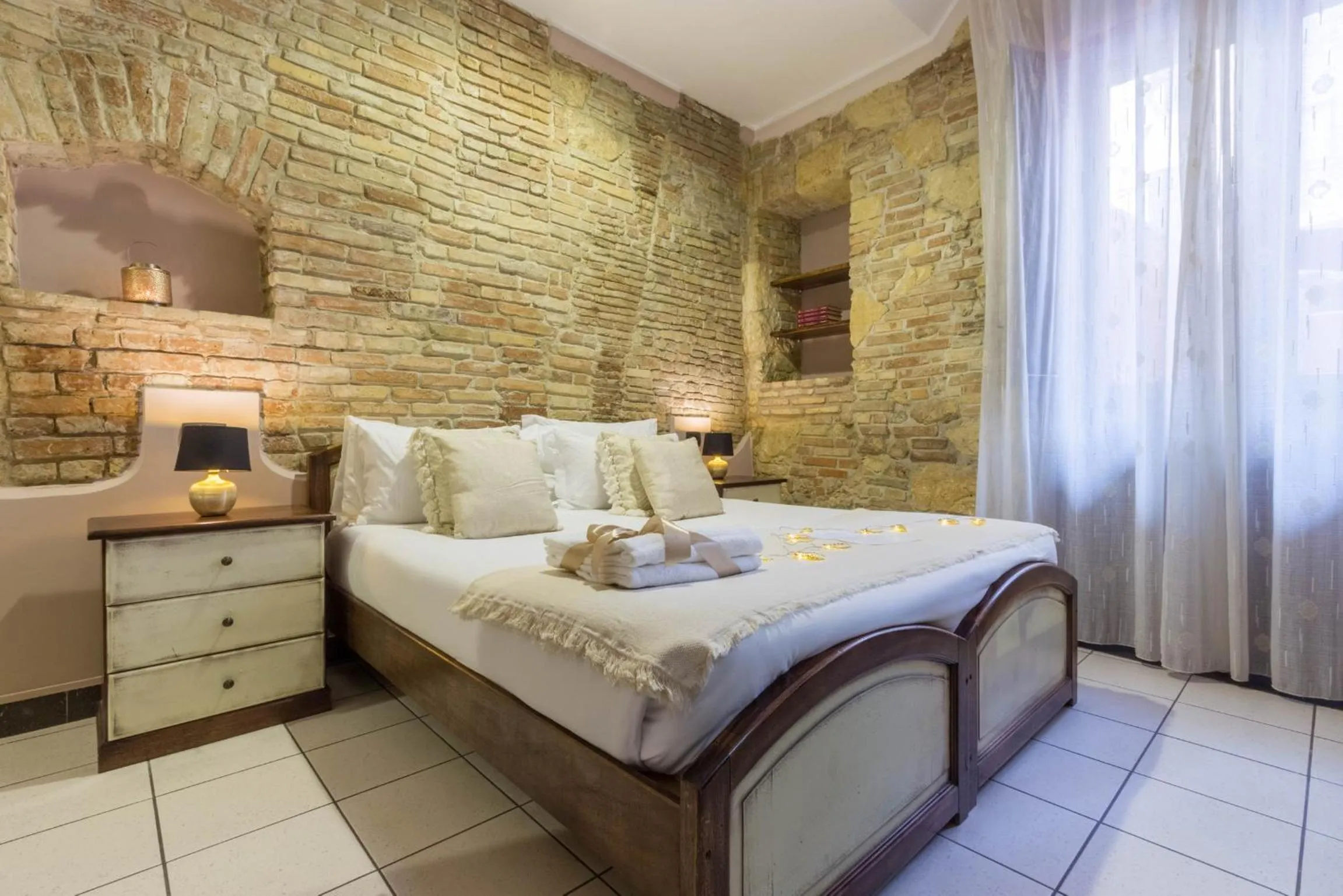 Bed in Arcobaleno Rooms