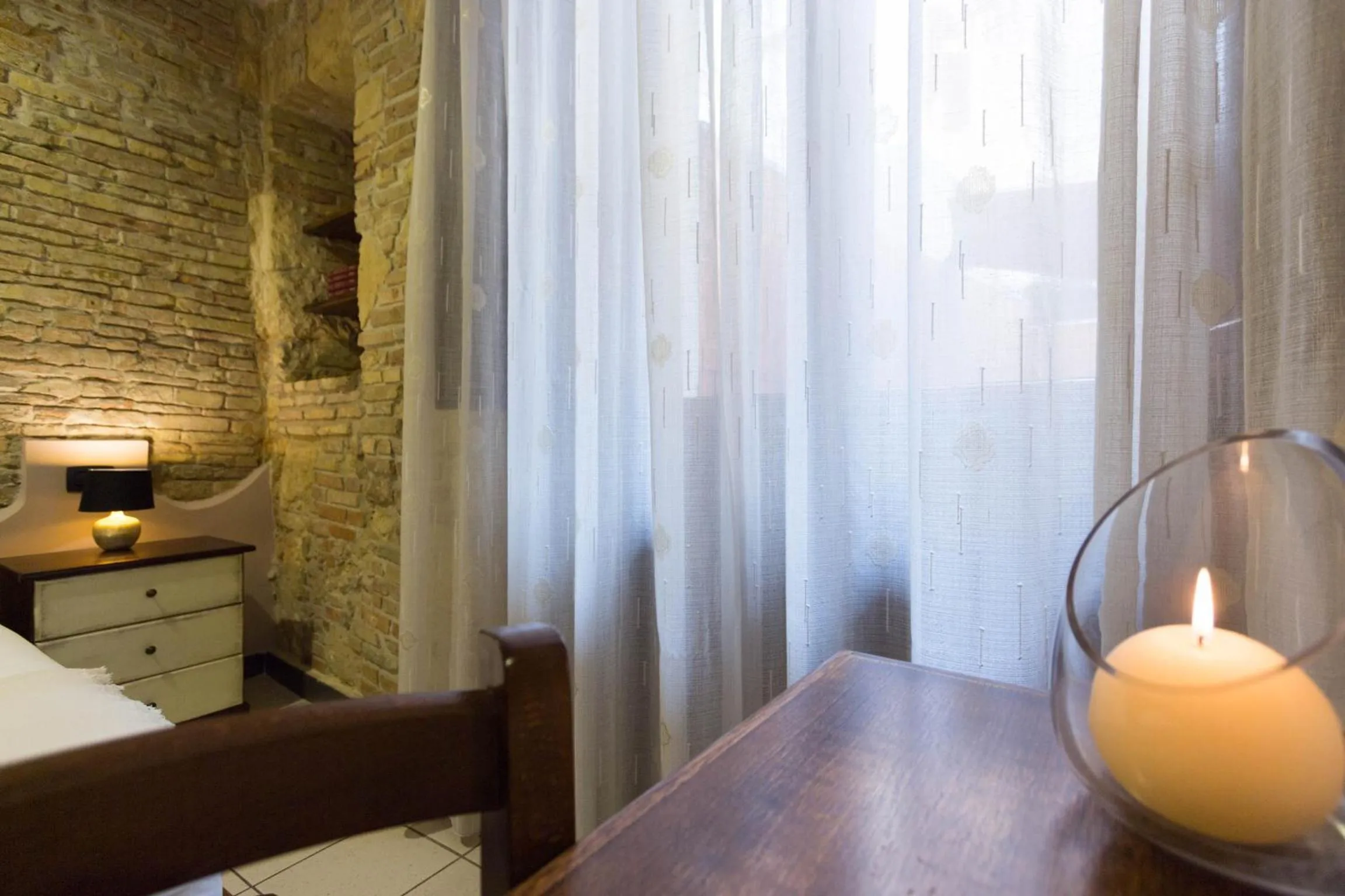 Bed in Arcobaleno Rooms