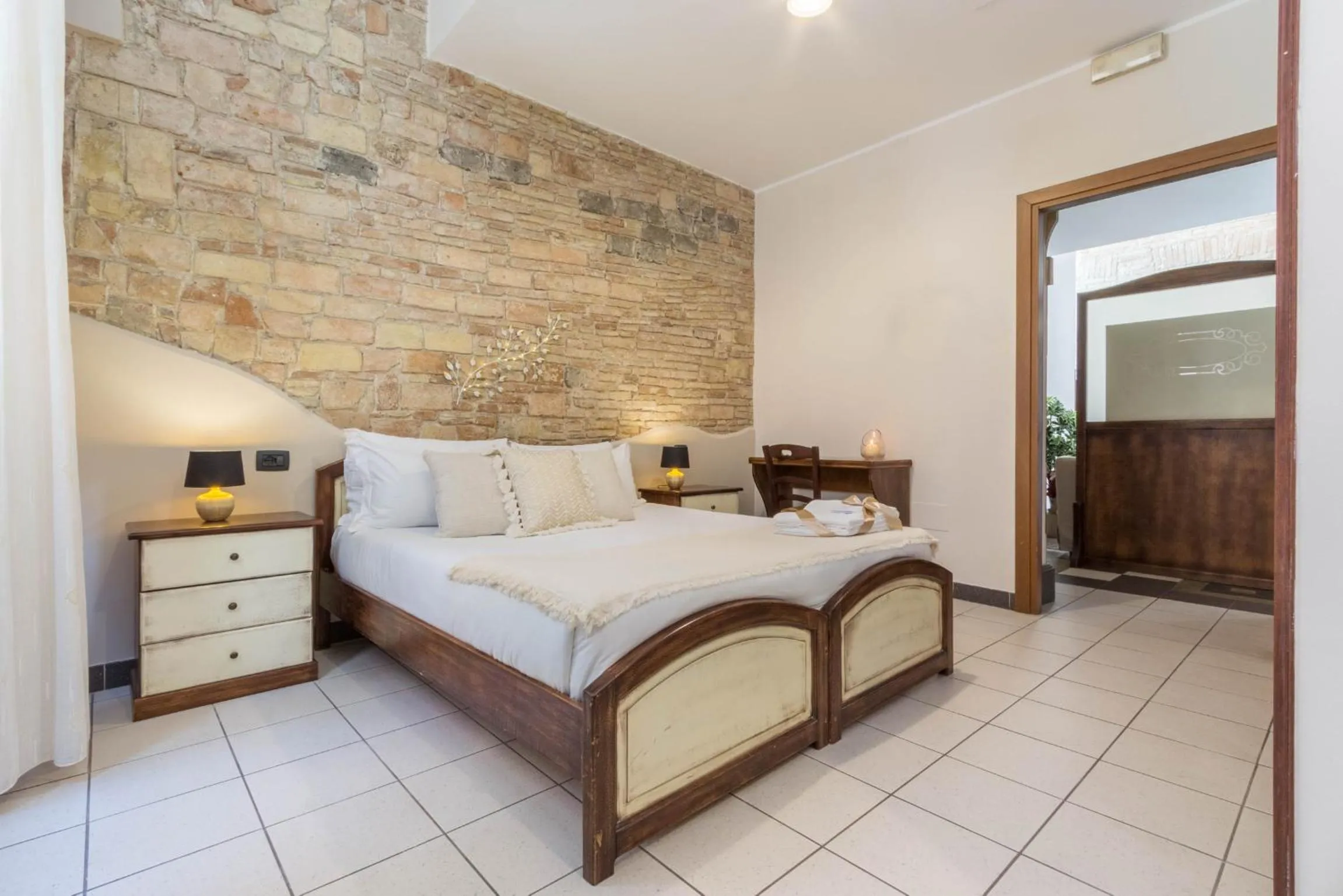 Bed in Arcobaleno Rooms