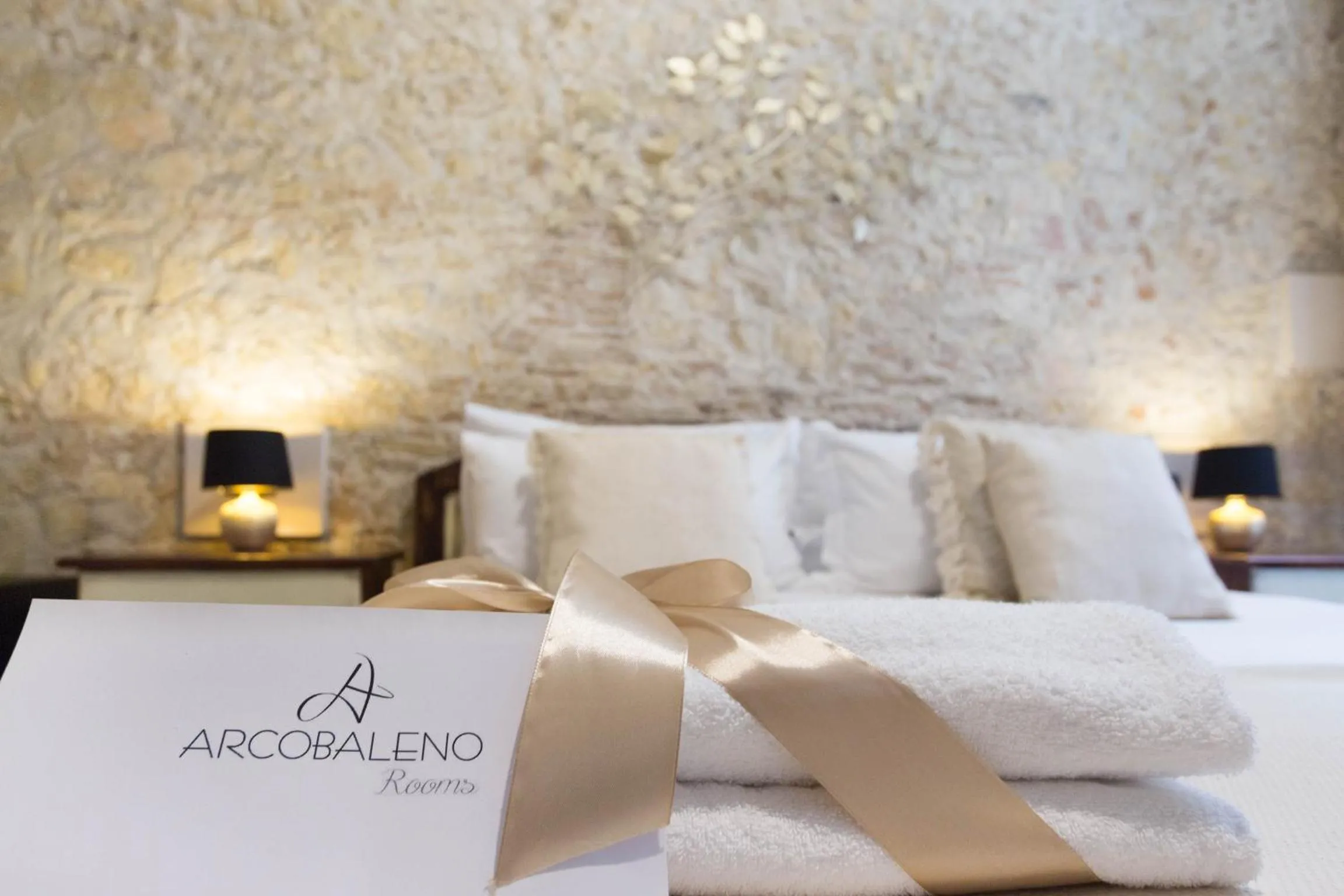 Bed in Arcobaleno Rooms