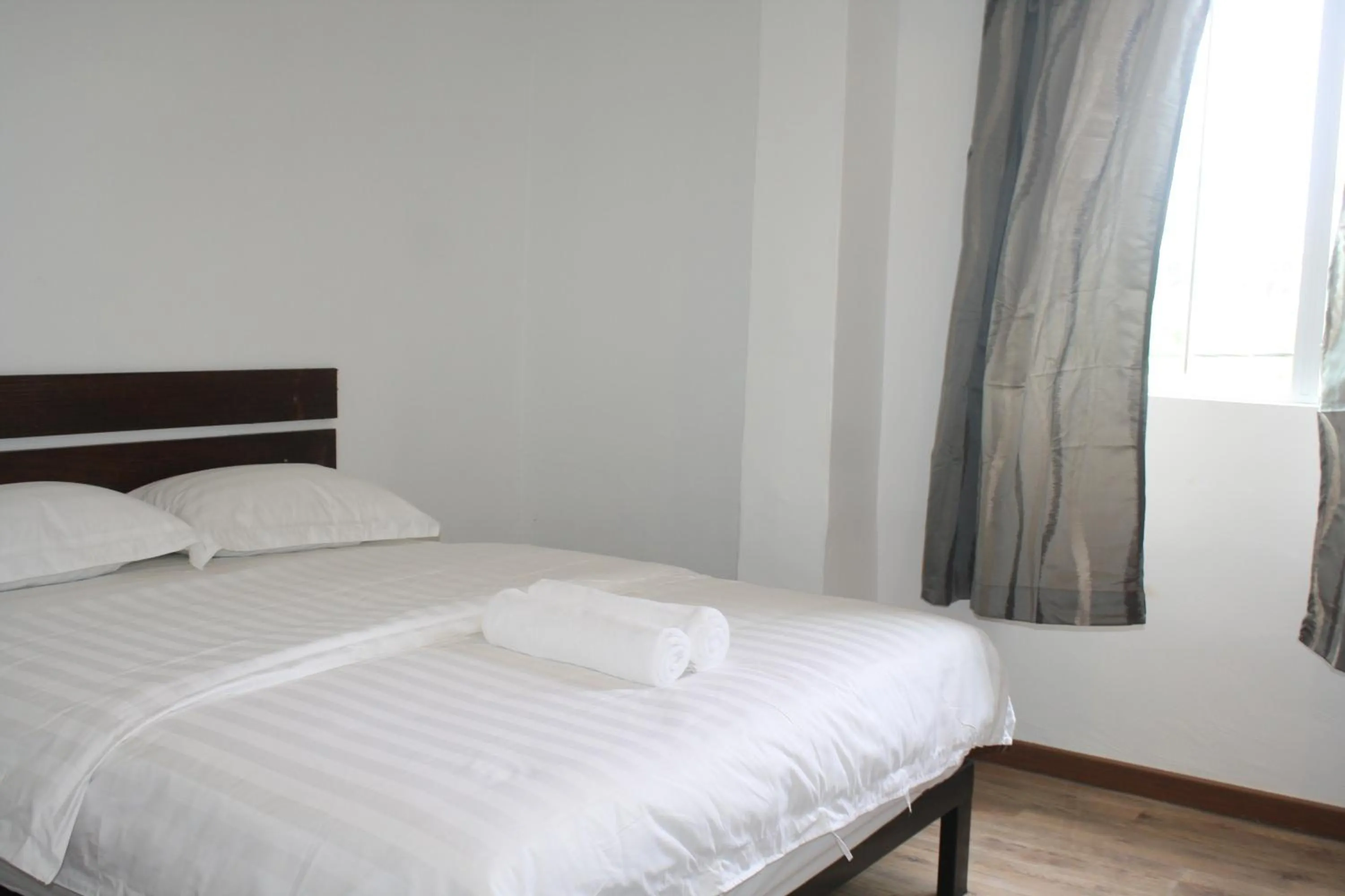 Bed in Cozy Riverside Hotel