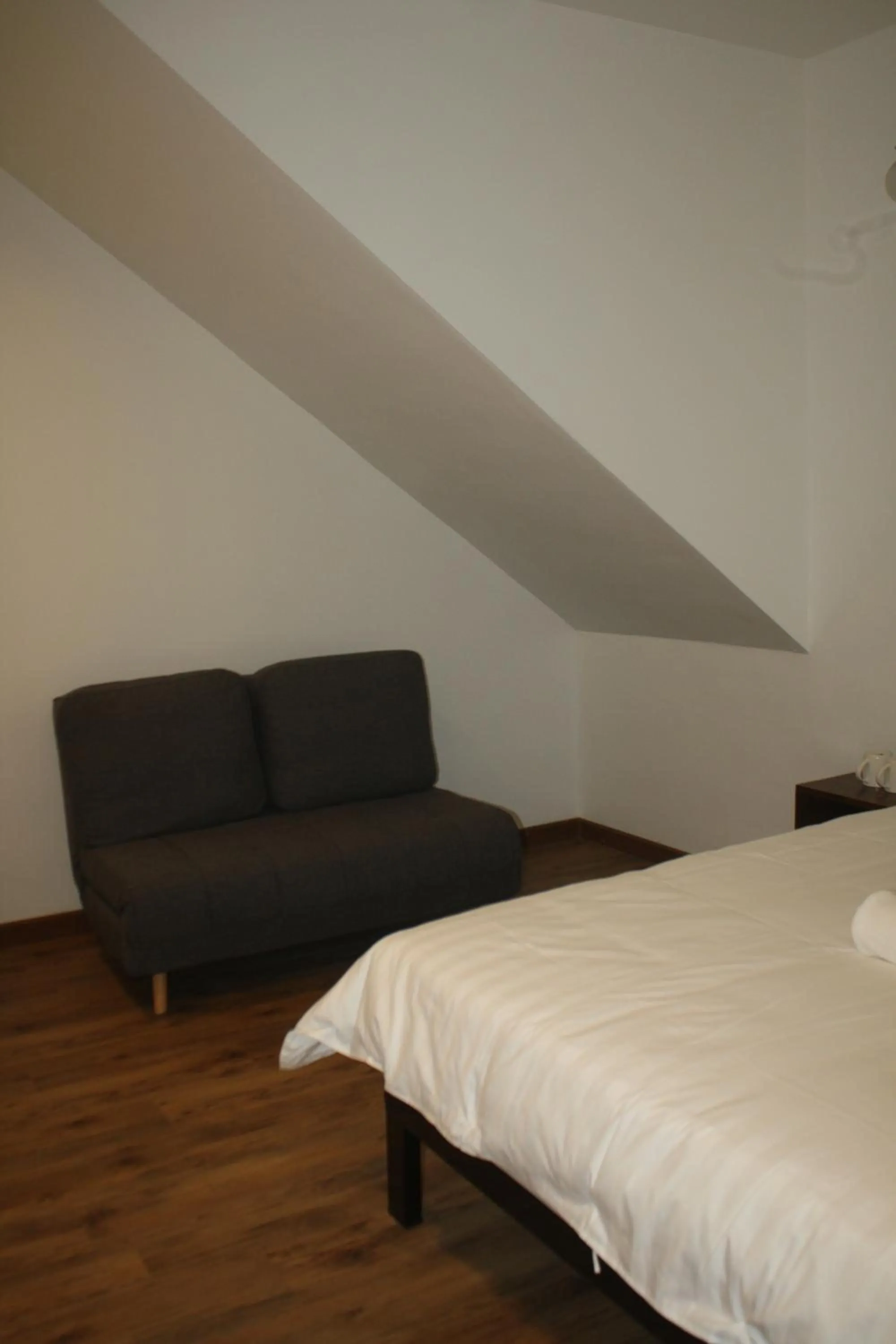 Bed in Cozy Riverside Hotel