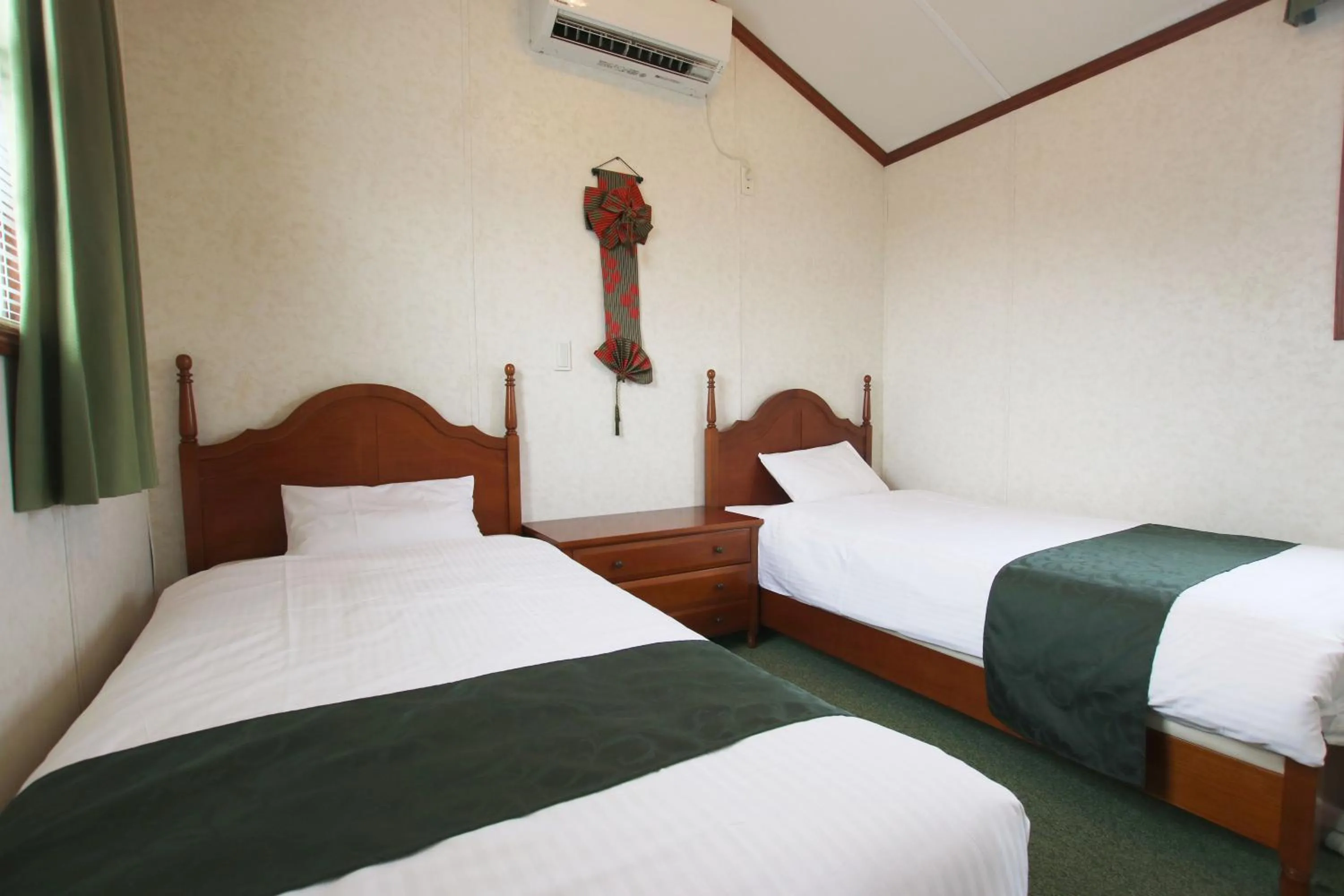 Bed in cottage NORTH OKINAWA -SEVEN HOTELS & Resorts-