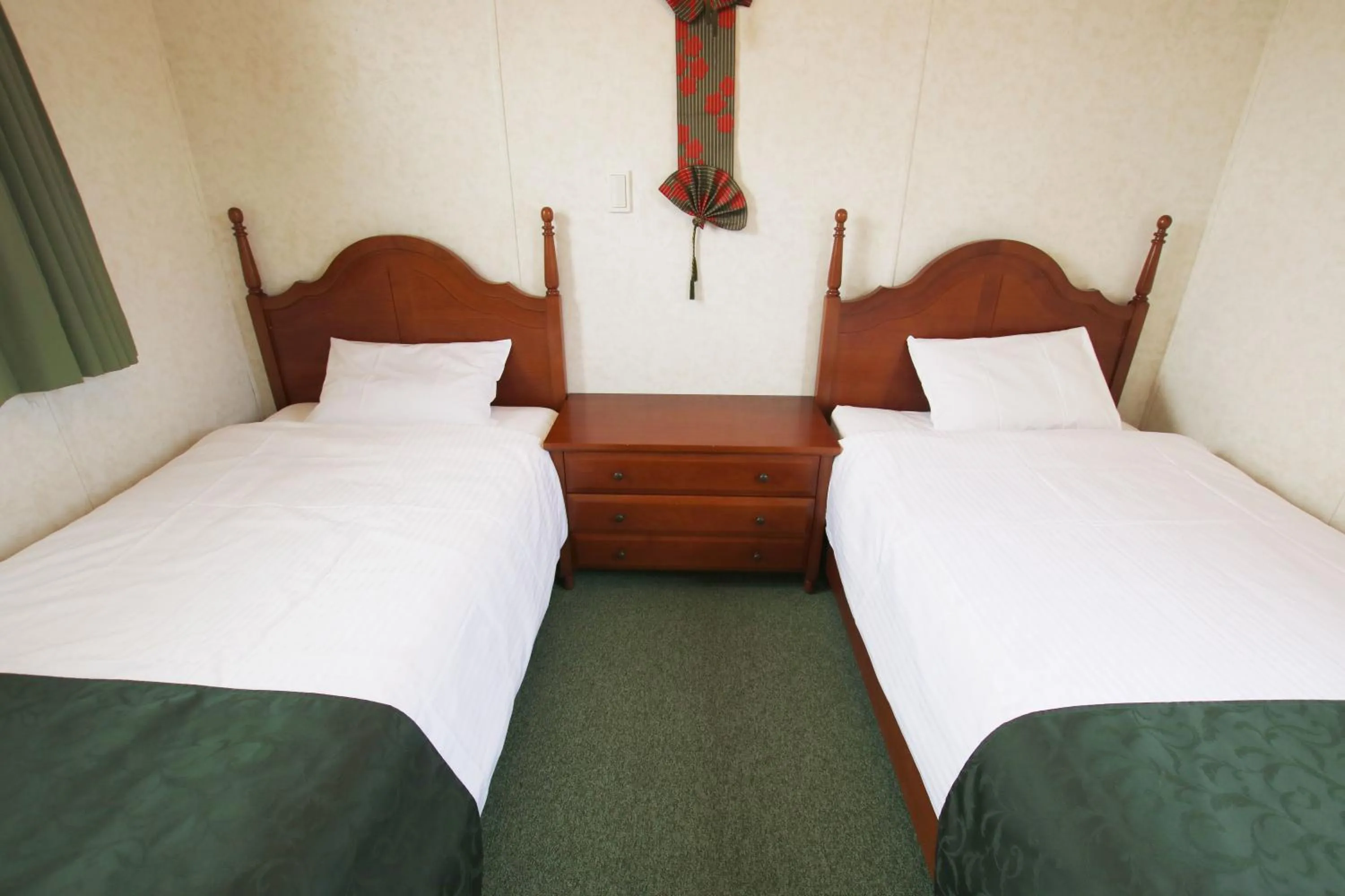 Bed in cottage NORTH OKINAWA -SEVEN HOTELS & Resorts-