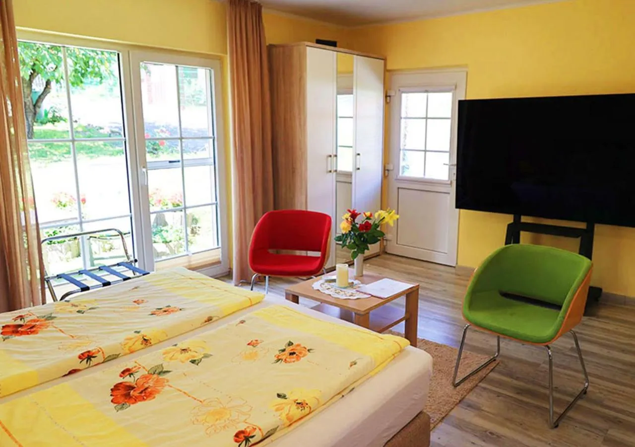 Communal lounge/ TV room, Bed in Hotel Haus Orchideental Jena