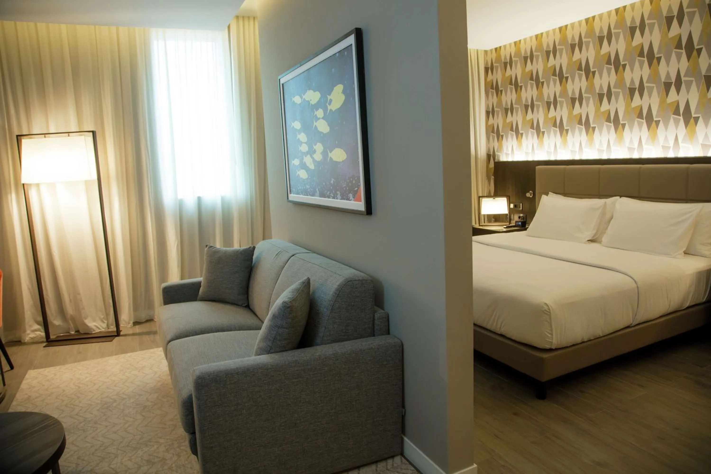 Living room, Bed in Doubletree By Hilton Pointe-Noire City Centre