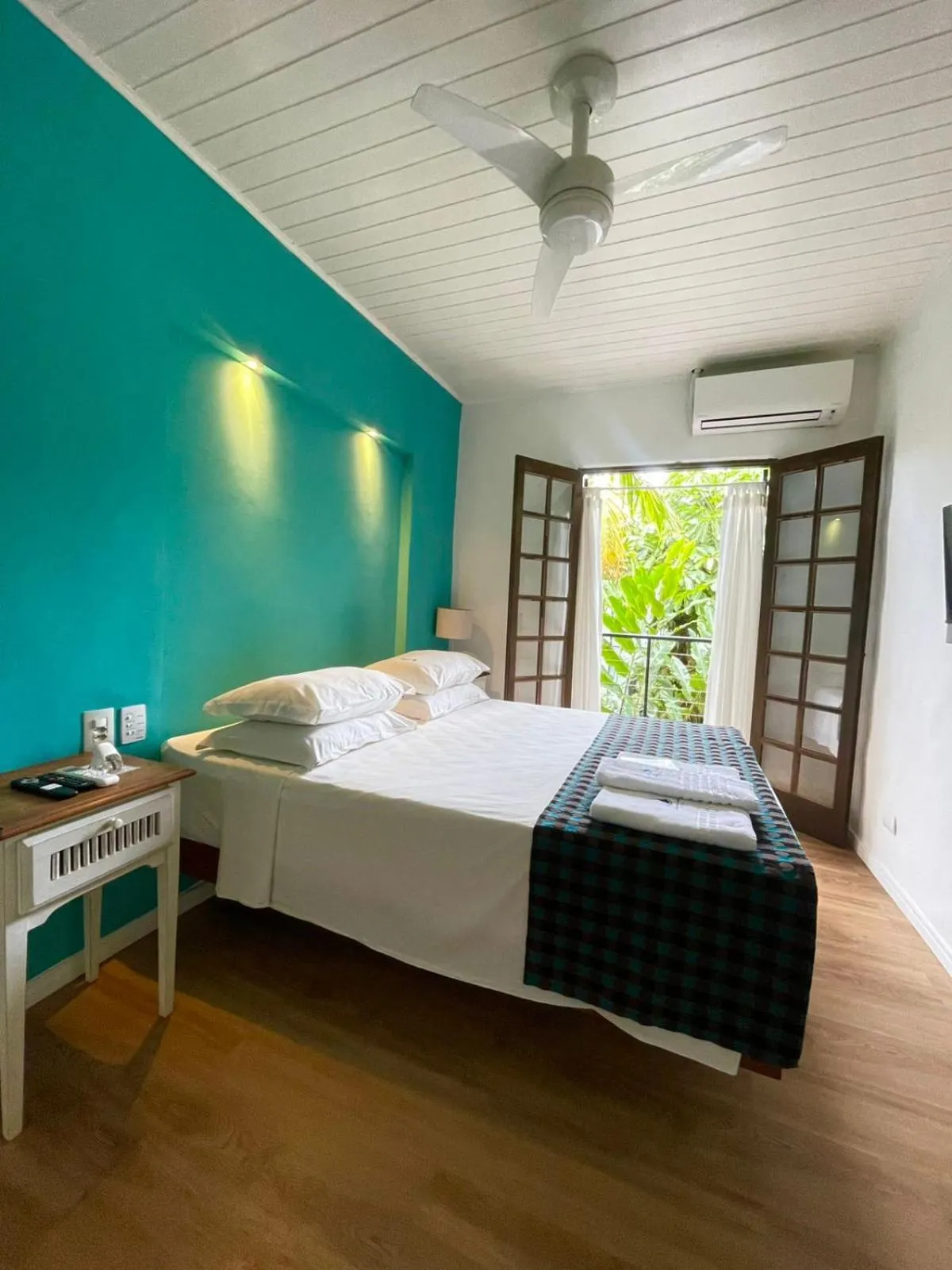 Bed in Pousada Armação de Camburi